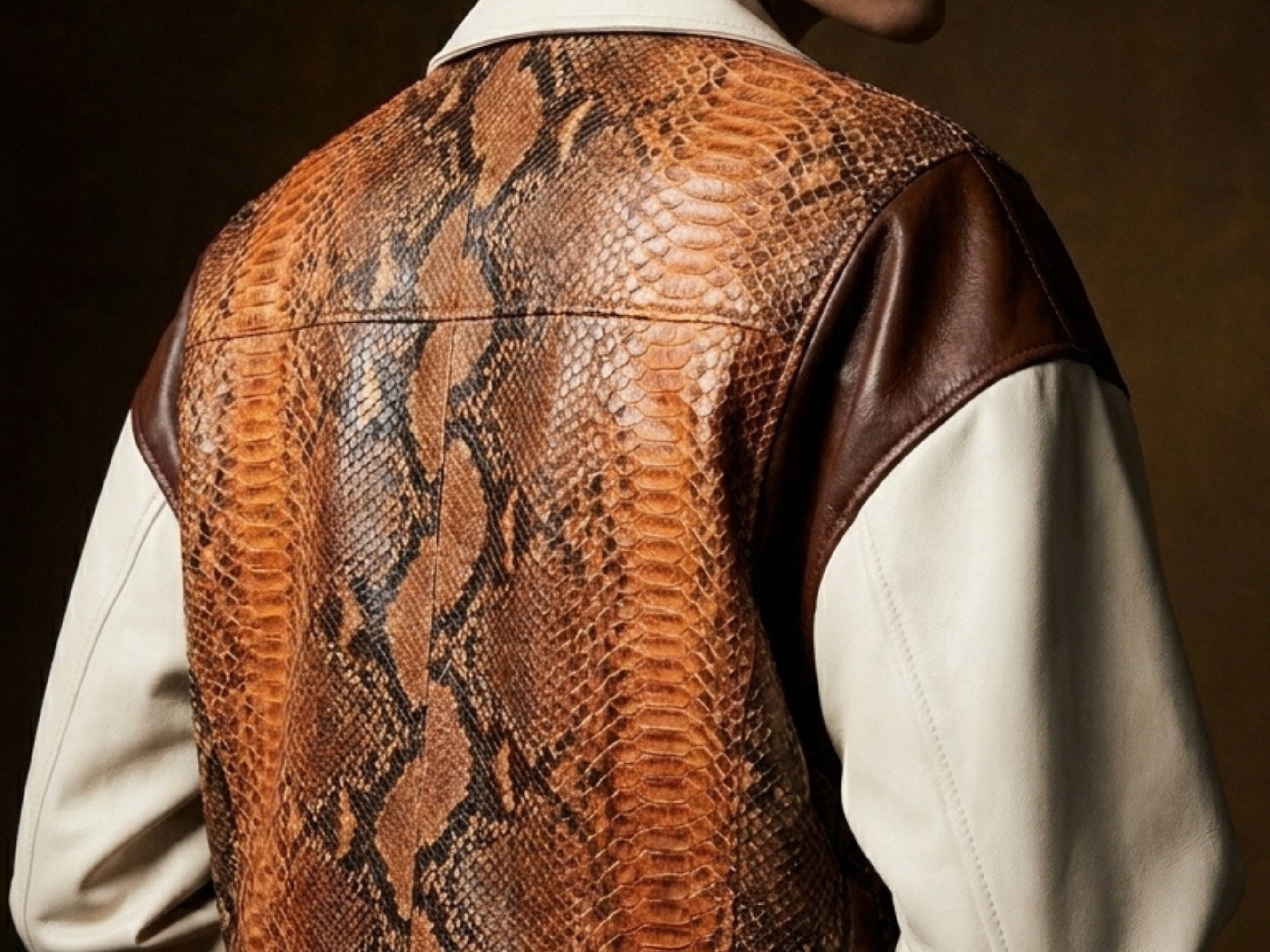 Close-up of back yoke with orange-brown snakeskin pattern and cream leather sleeves