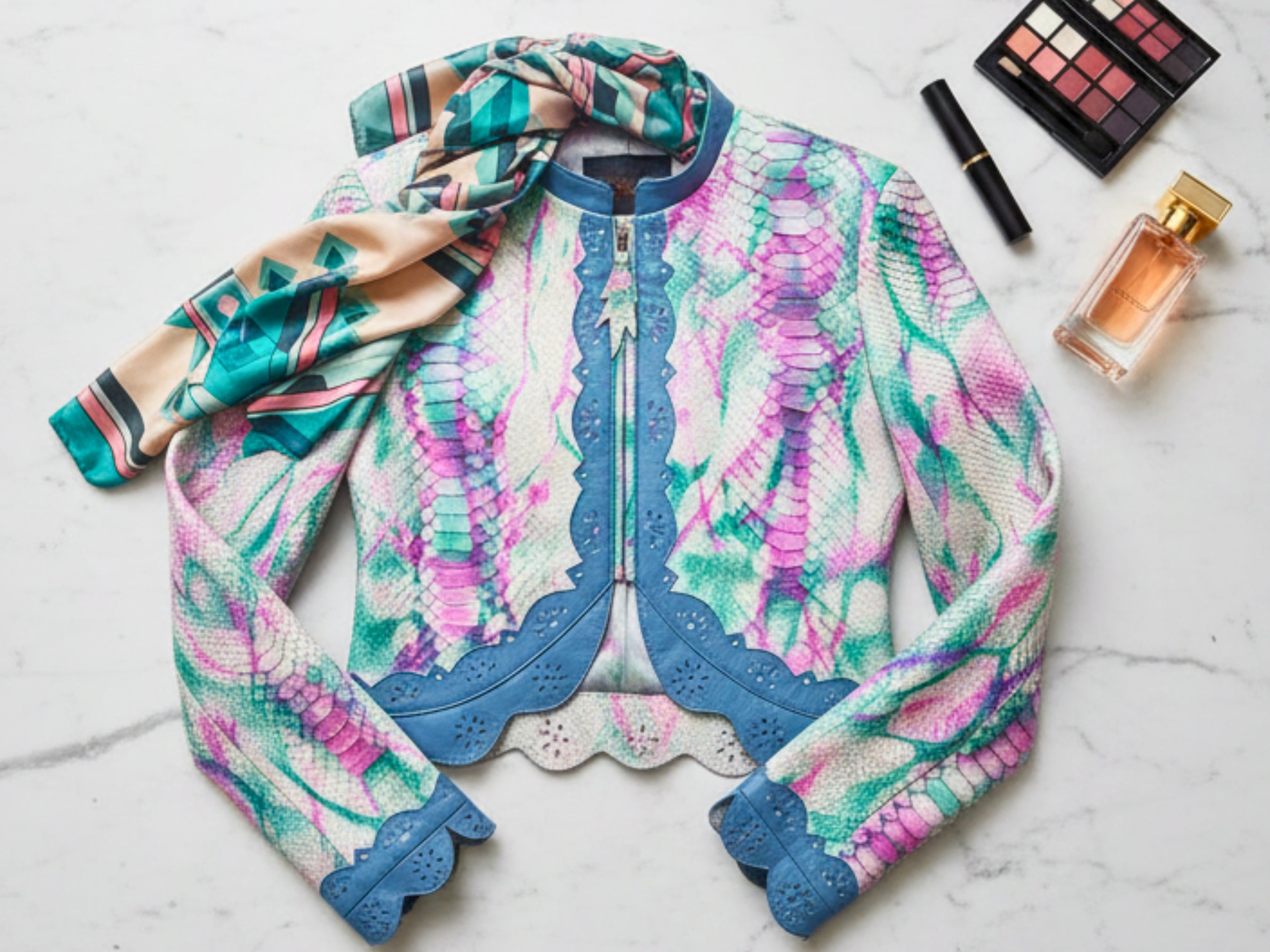 Cropped leather jacket flat lay, multicolor snakeskin tie-dye with blue trim and cuffs