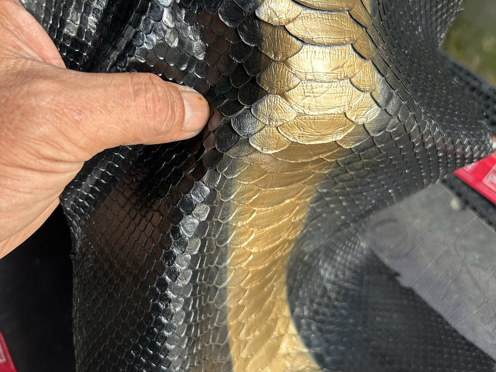Close-up of black python-print leather with gold center stripe panel