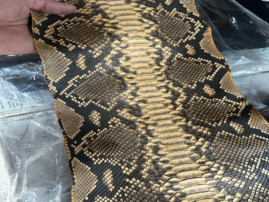 Snakeskin leather jacket close-up, natural brown python scale texture panel