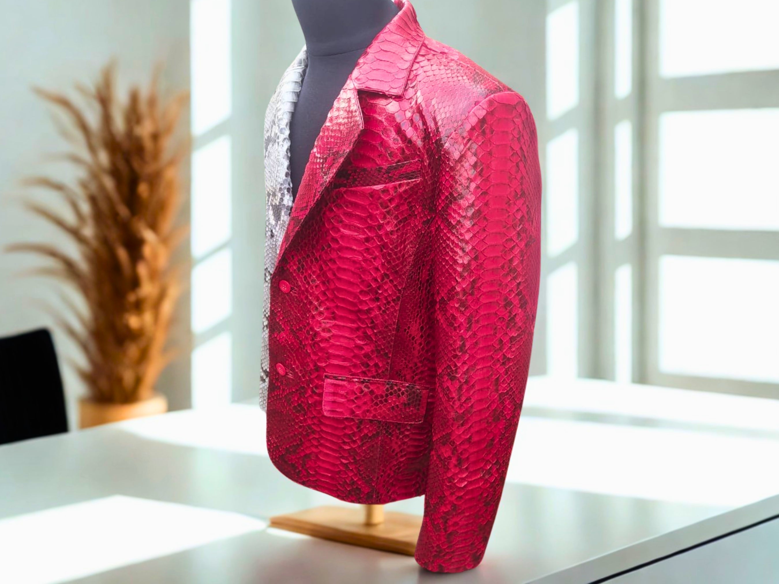 Snakeskin blazer side view, vivid red and silver snake-print, button front.