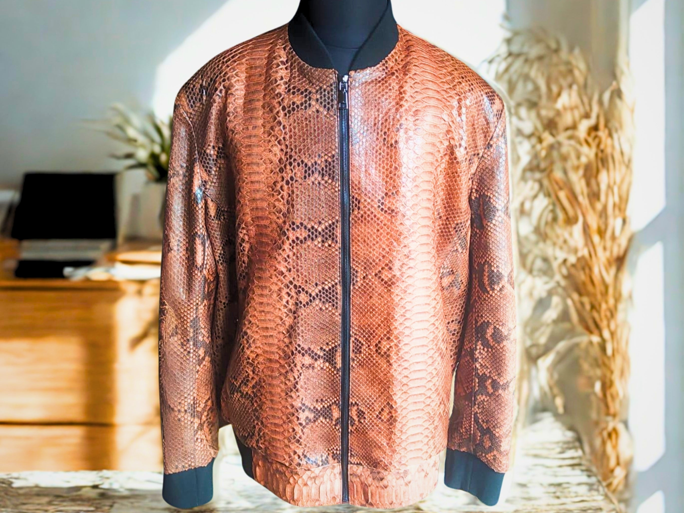 Brown leather bomber jacket with scaly snakeskin pattern, front zipper, ribbed cuffs