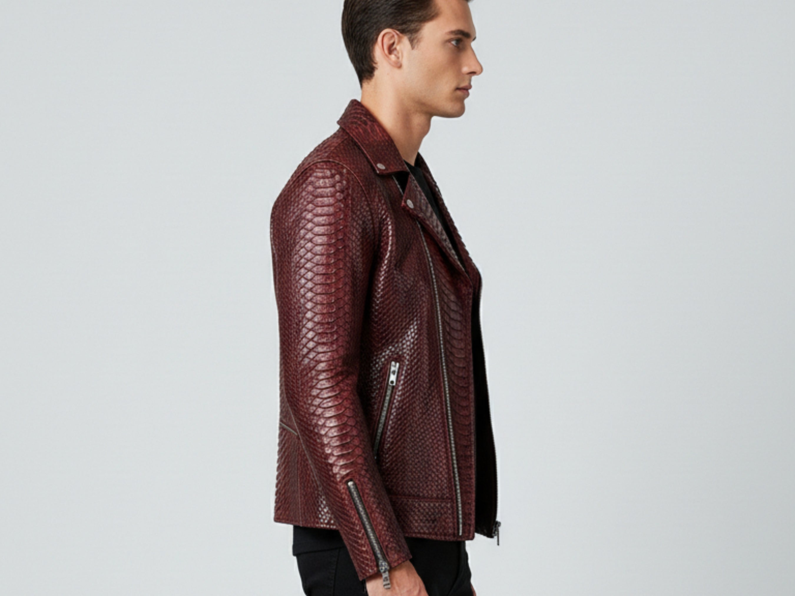 Burgundy python snakeskin leather biker jacket side view with zip pocket and cuff zips