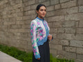 Cropped leather jacket with multicolor snakeskin tie-dye print and blue trim, side view