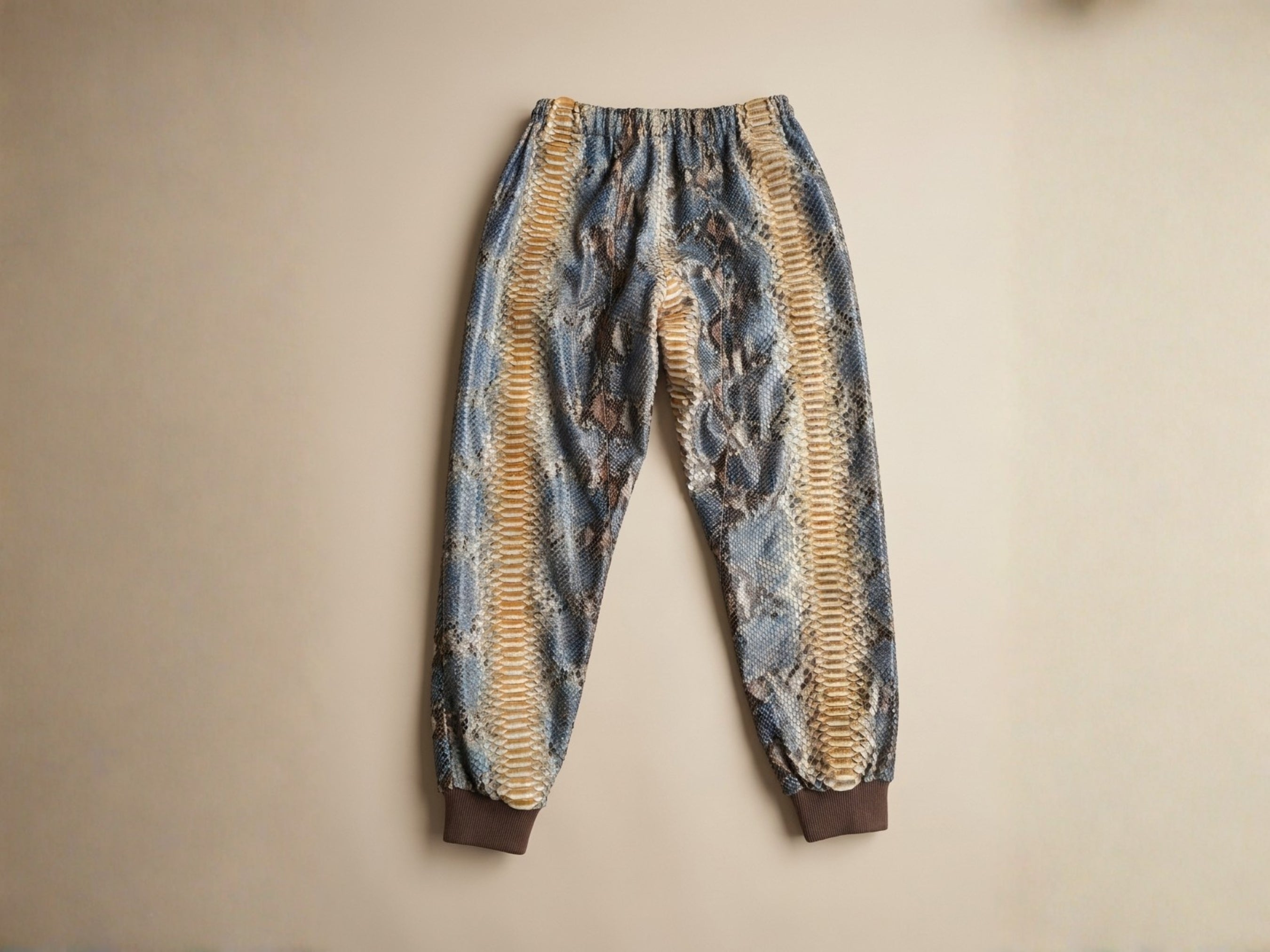 Python snakeskin printed jogger pants with elastic cuffs and waistband