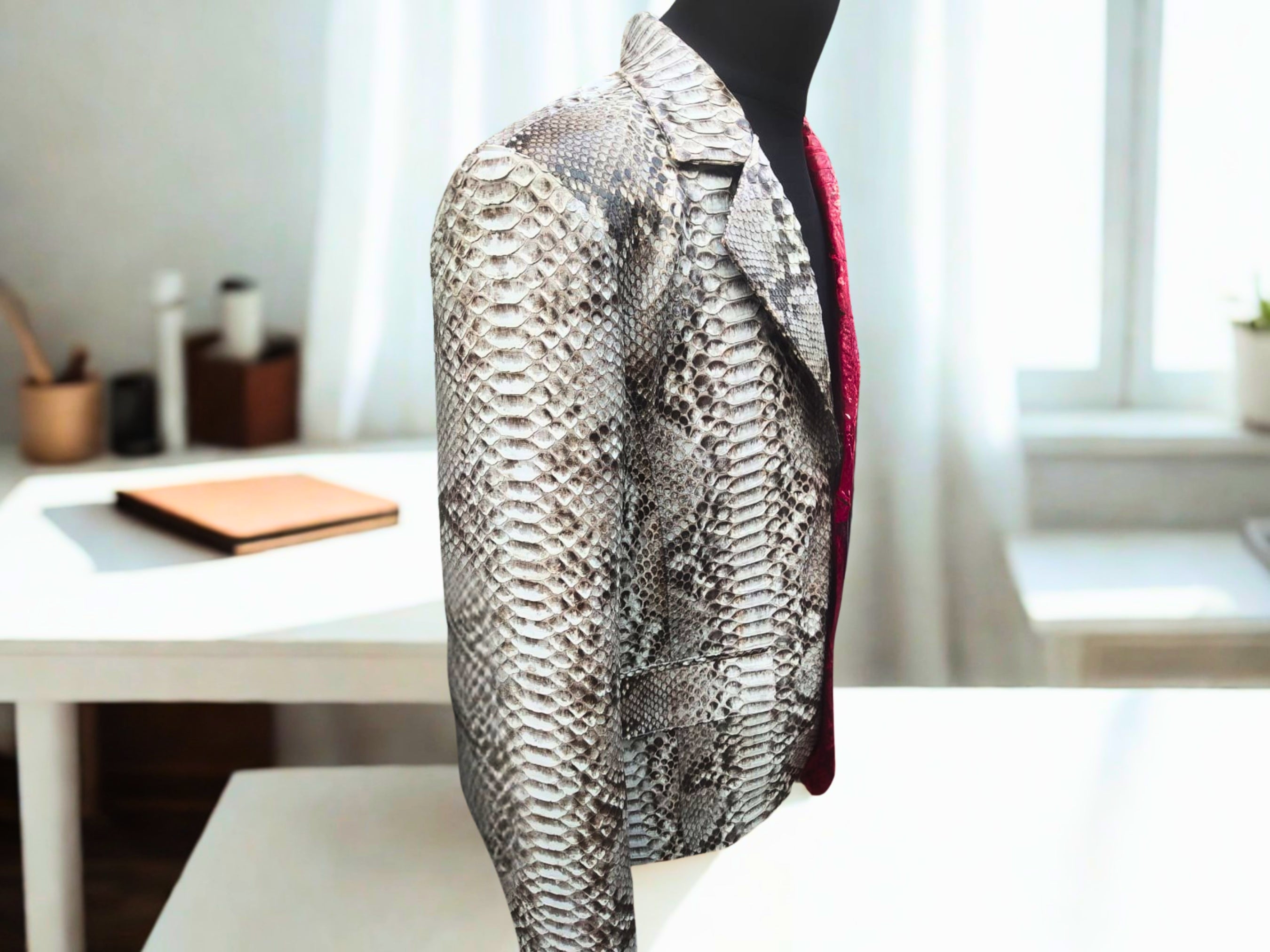 Snakeskin blazer side view, silver snake-print with red inner panel detail.