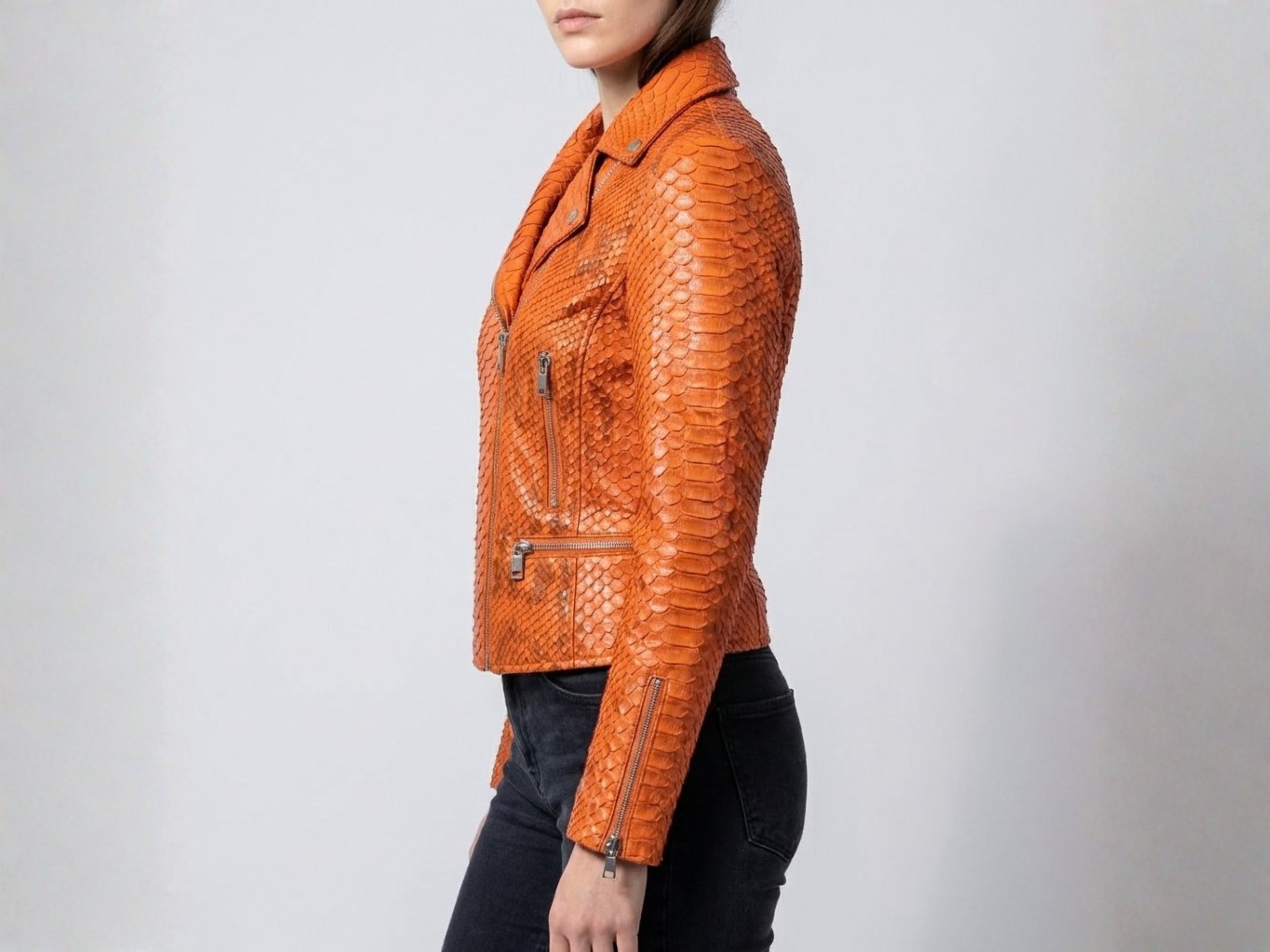 Burnt orange snakeskin-texture leather biker jacket sleeve detail with zip cuff and side hardware
