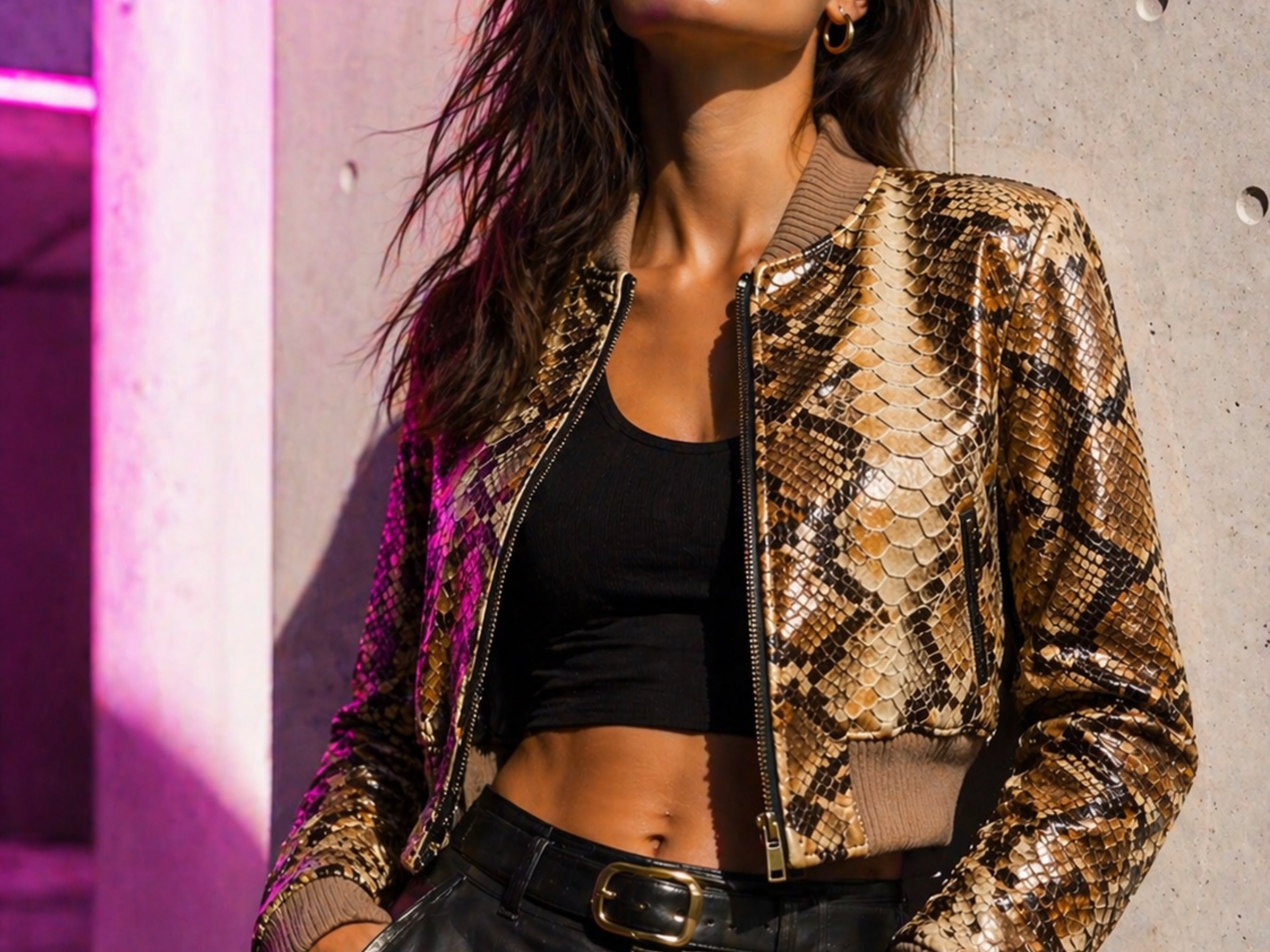 Cropped snakeskin bomber jacket with front zip and ribbed collar, worn with black pants