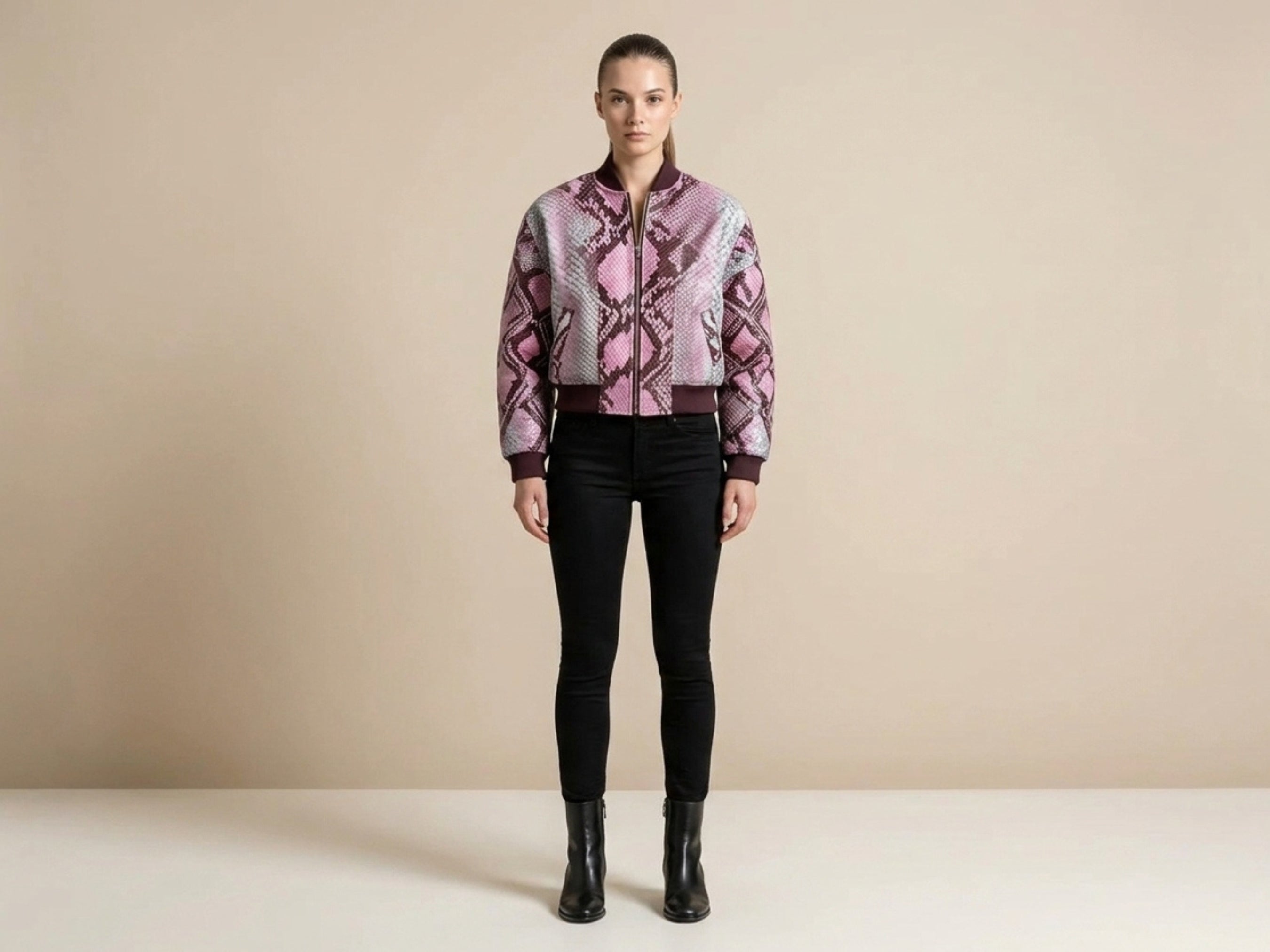 Blush pink snakeskin bomber jacket with full-zip front and maroon ribbed trim