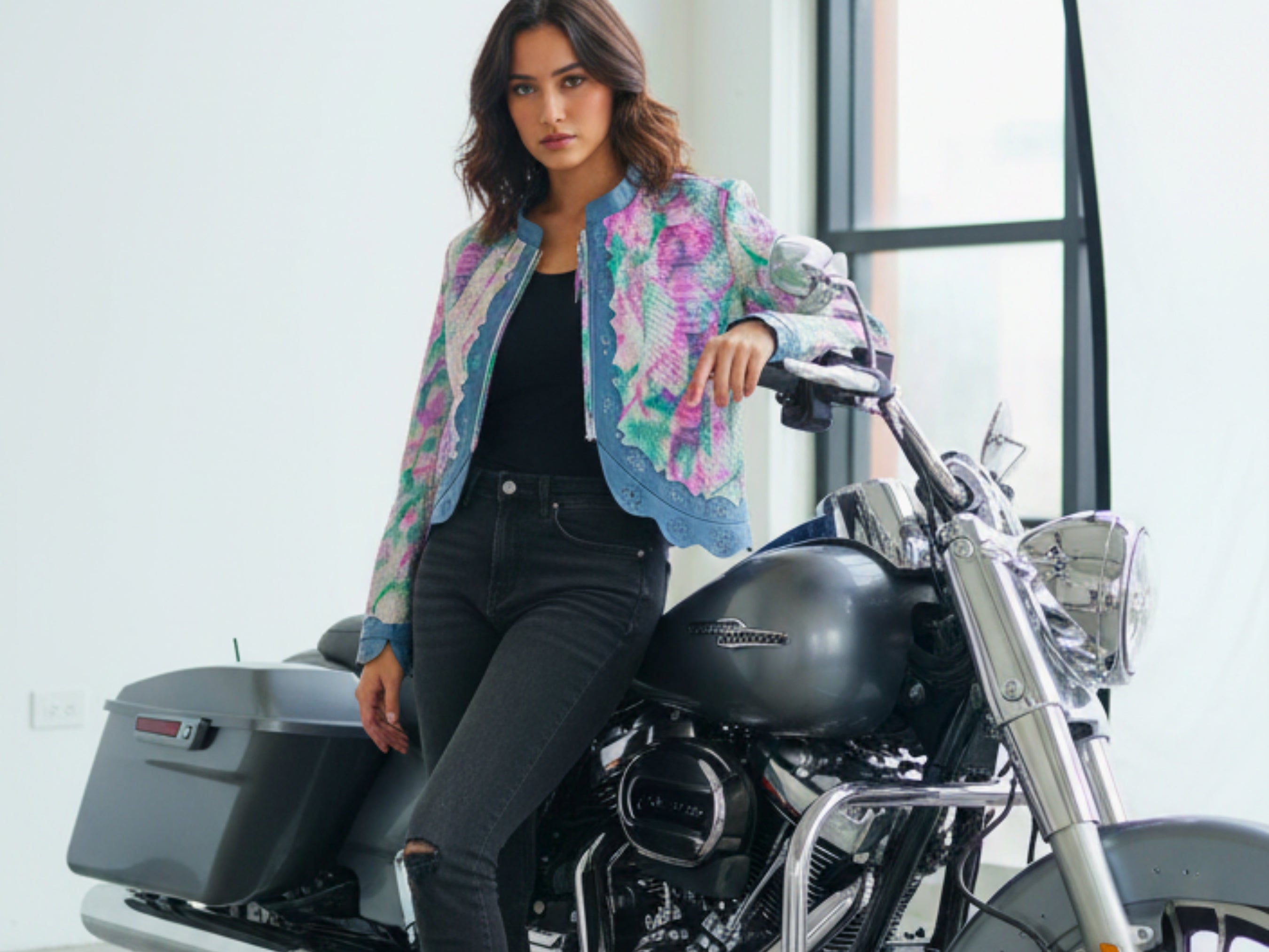 Cropped leather jacket with multicolor snakeskin tie-dye and blue trim, casual styling