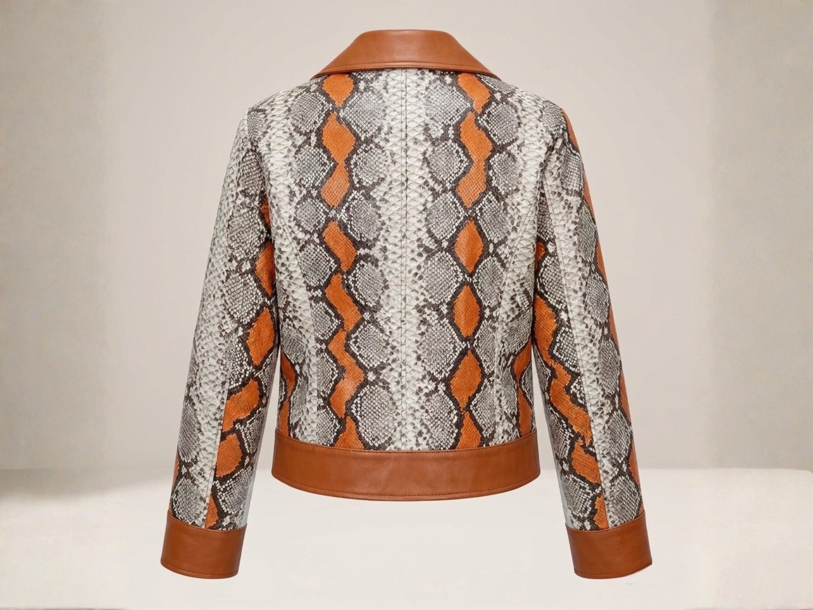 Women’s back view snakeskin biker leather jacket with orange and brown scale pattern.