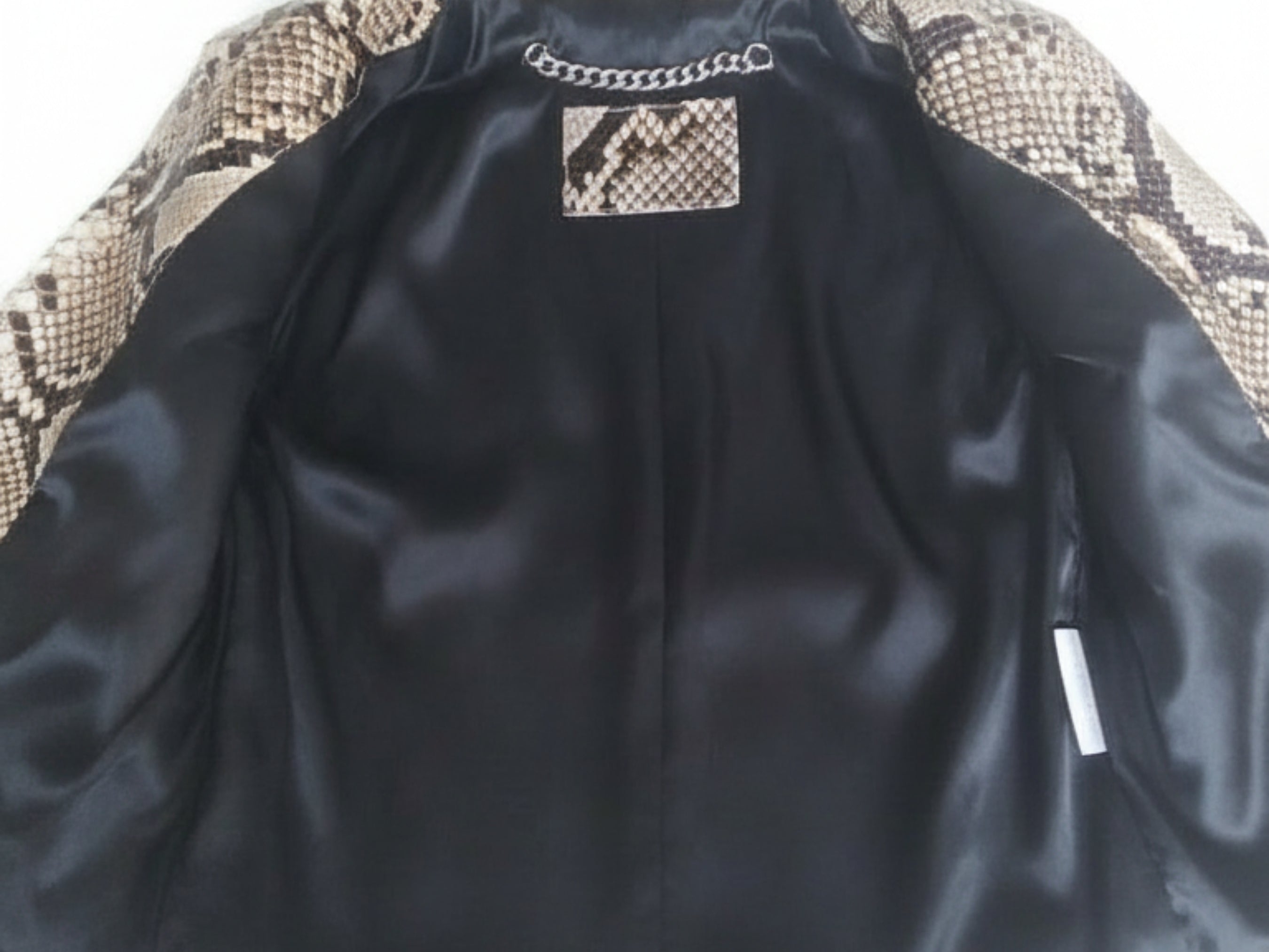 Black satin lining inside a python-skin biker jacket opening