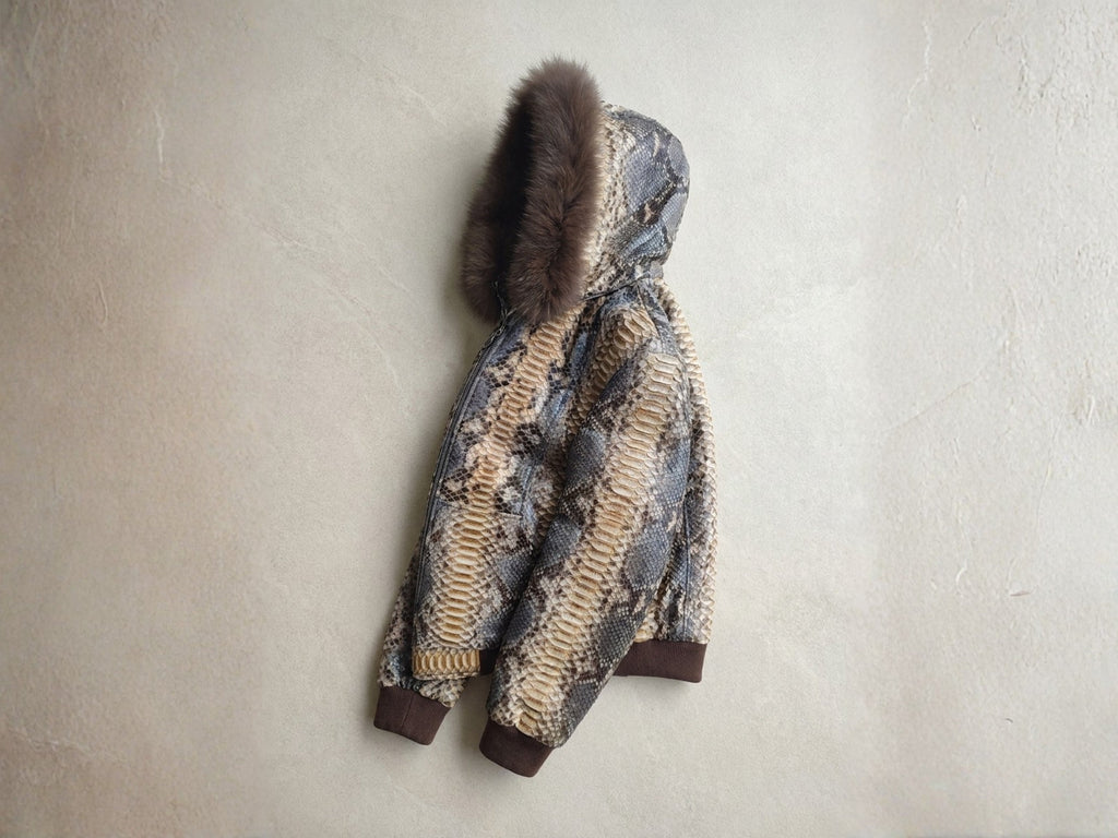 Python snakeskin hoodie with dark fur-trim hood; front zipper and ribbed cuffs