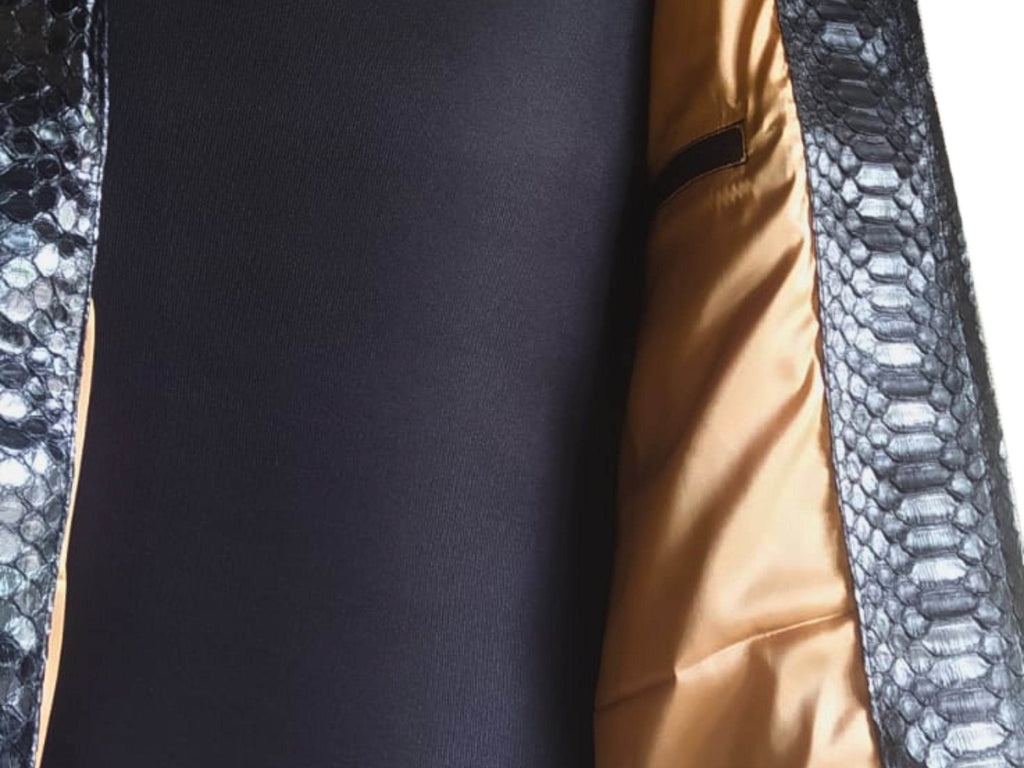 Cafe racer leather jacket close-up: black interior panel and gold lining with snakeskin trim