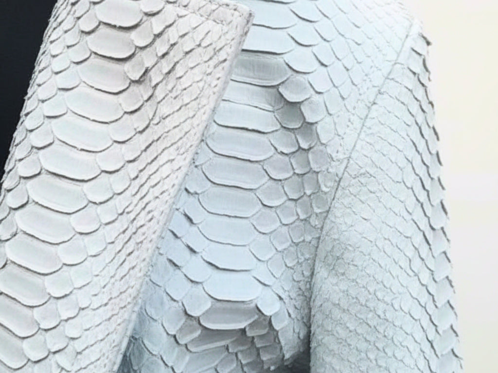 Close-up of light blue python-textured leather with scale pattern
