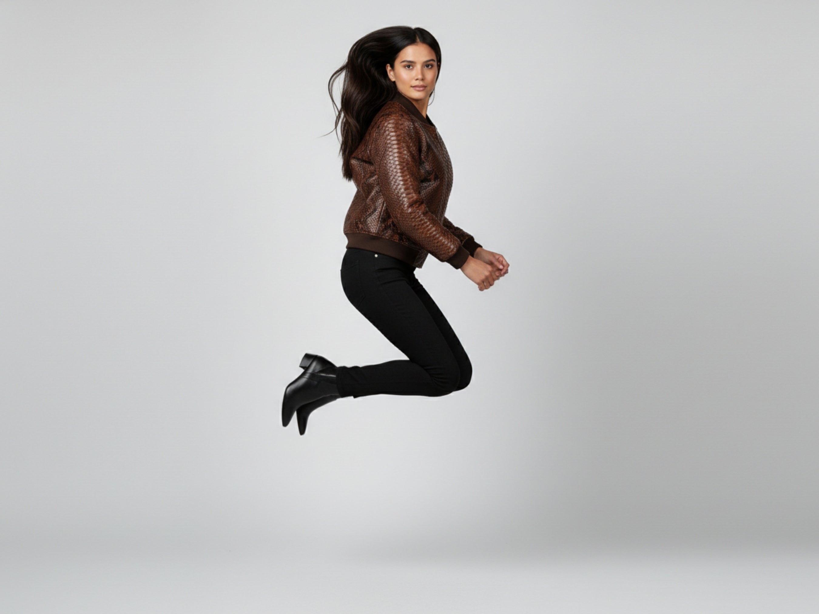 Brown snakeskin leather bomber jacket, dynamic pose with zip front and knit cuffs