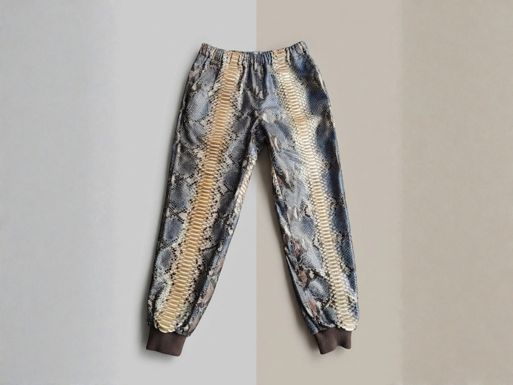 Python snakeskin printed jogger pants with ribbed cuffs and gathered elastic waist