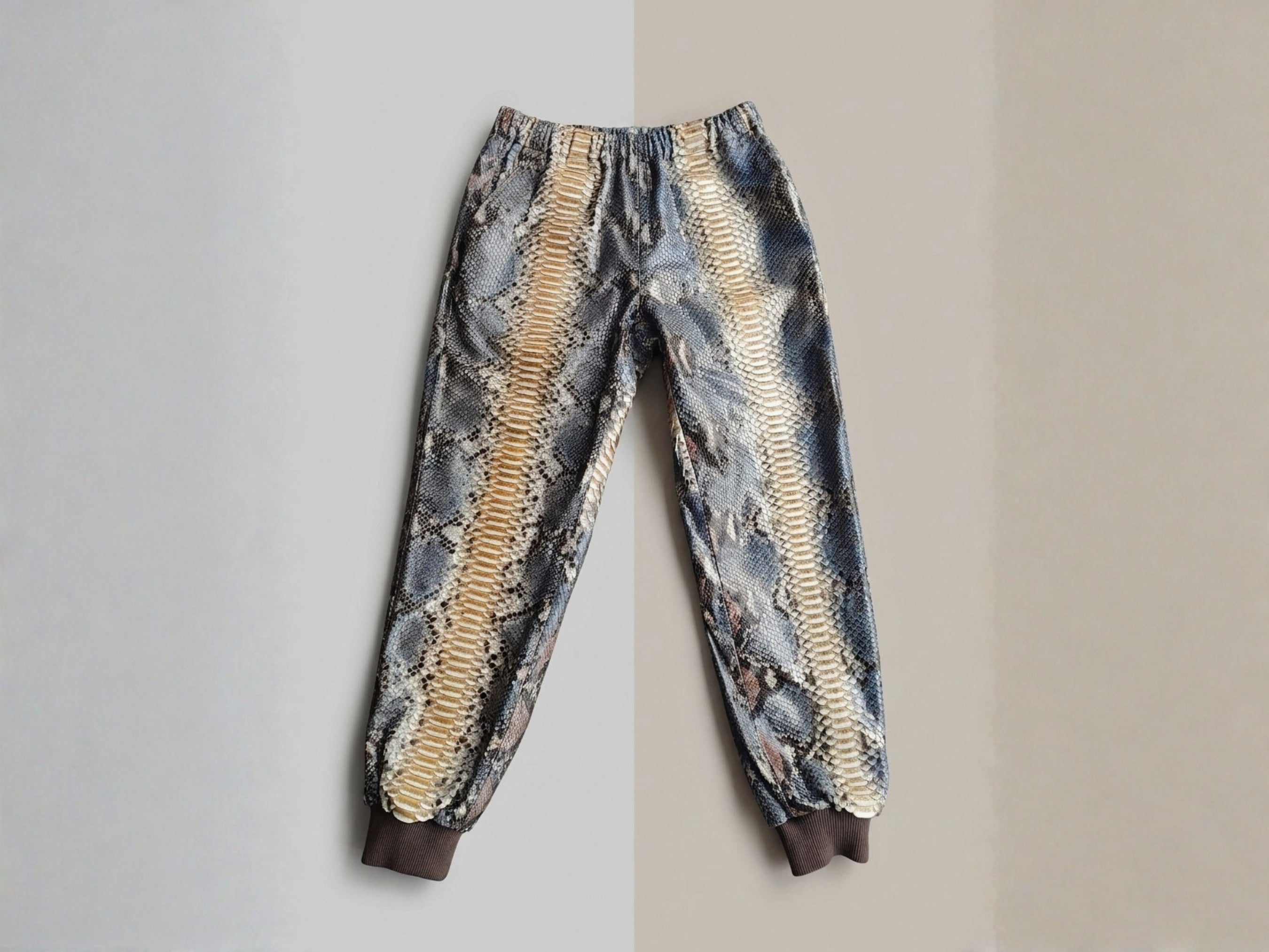 Python snakeskin printed jogger pants with ribbed cuffs and gathered elastic waist