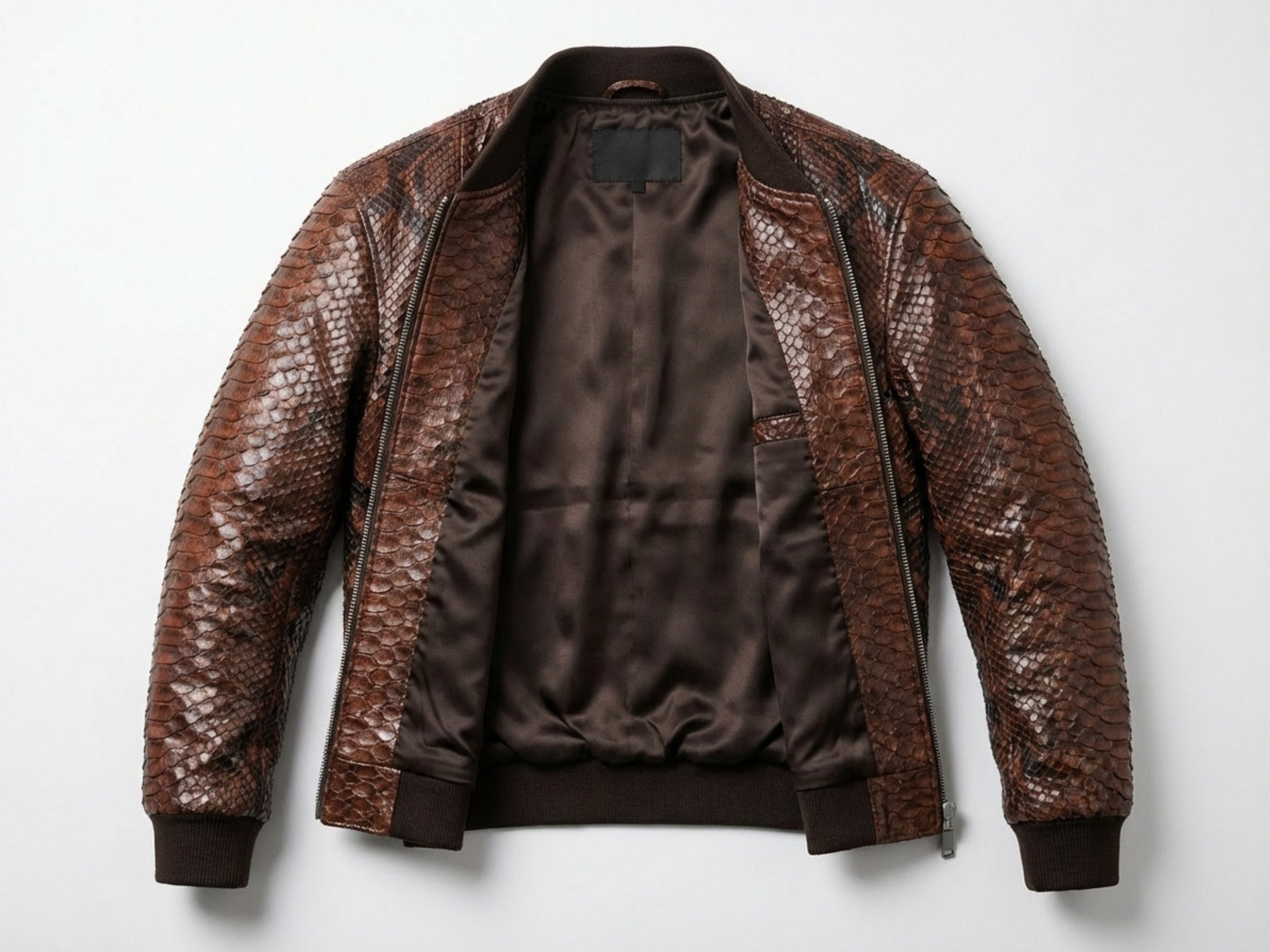 Brown snakeskin leather bomber jacket laid open, showing black inner lining