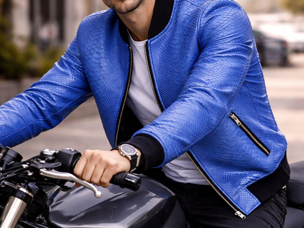 Blue snakeskin-textured bomber jacket detail: zip pocket, black rib cuff, black trim