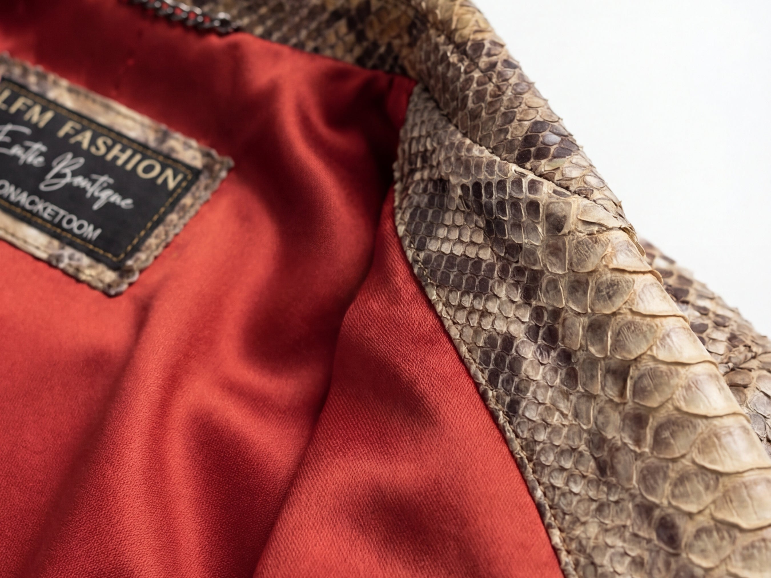 Close-up of python-effect jacket lining with red interior and stitched brand patch