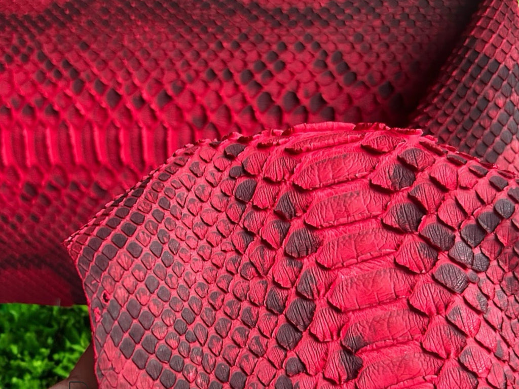 Close-up of red python snakeskin leather texture with raised scale pattern