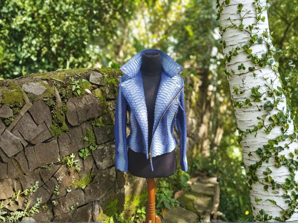 Blue snakeskin-effect biker jacket hanging display with asymmetrical zipper and lapels.