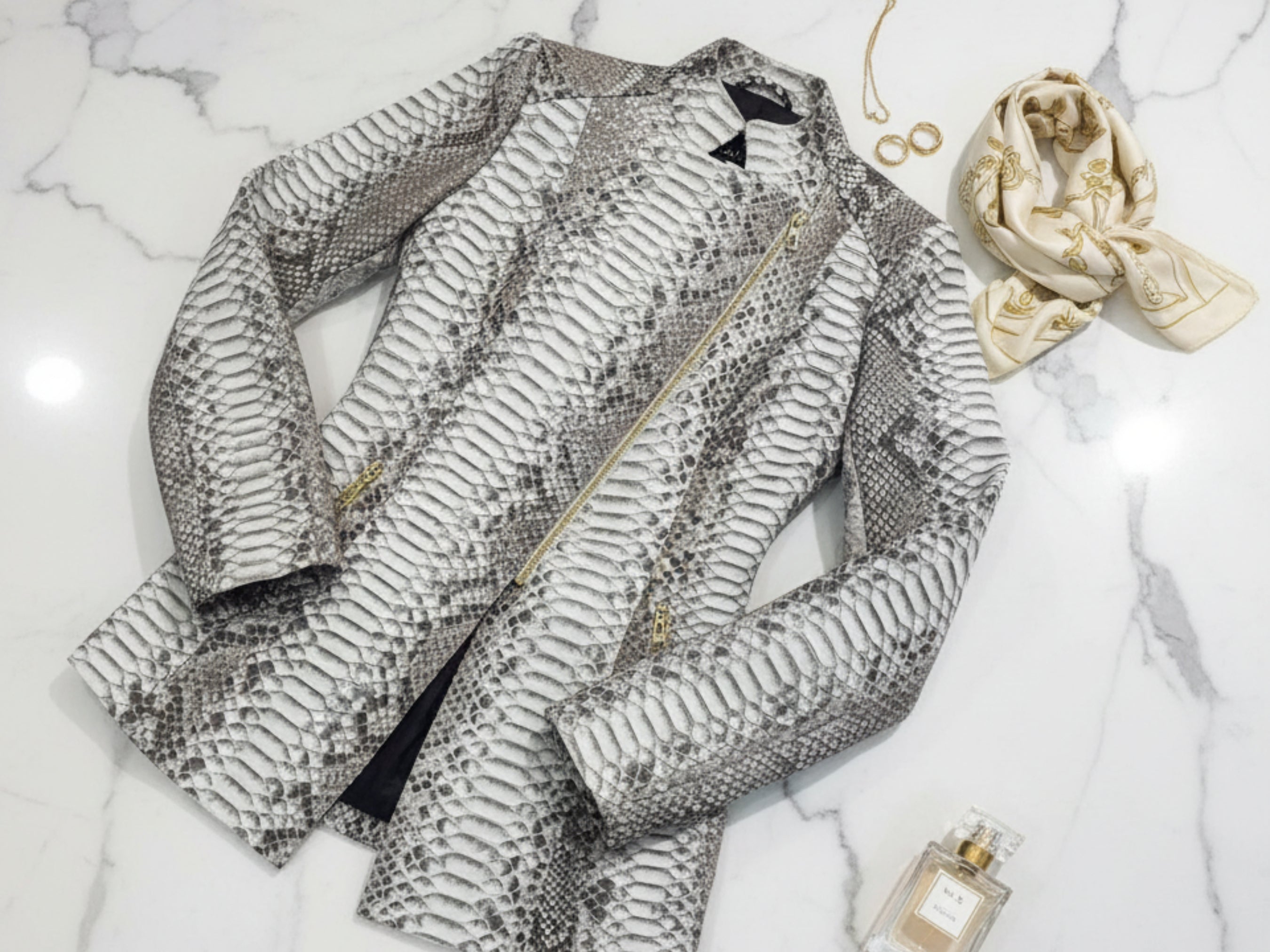 Gray python snakeskin jacket with asymmetrical zip, long sleeves, and stand collar