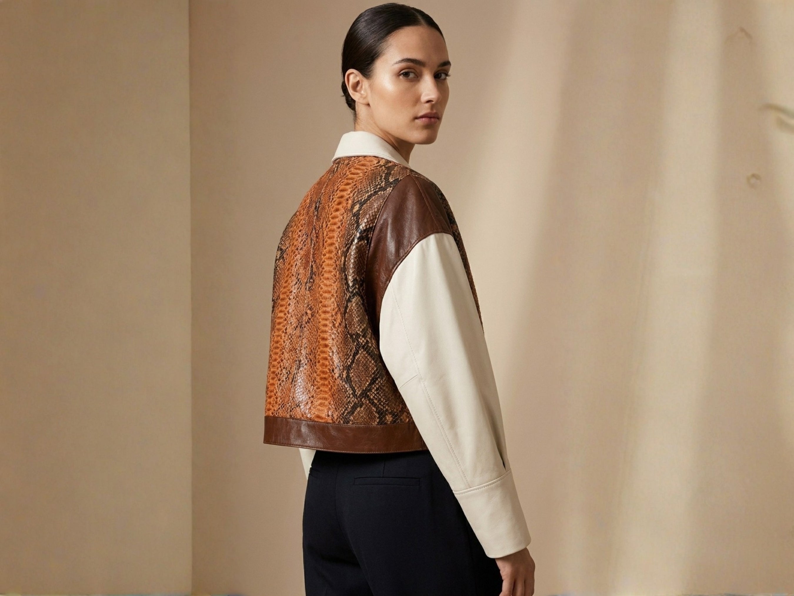 Side view blazer with orange-brown snakeskin section and cream sleeves