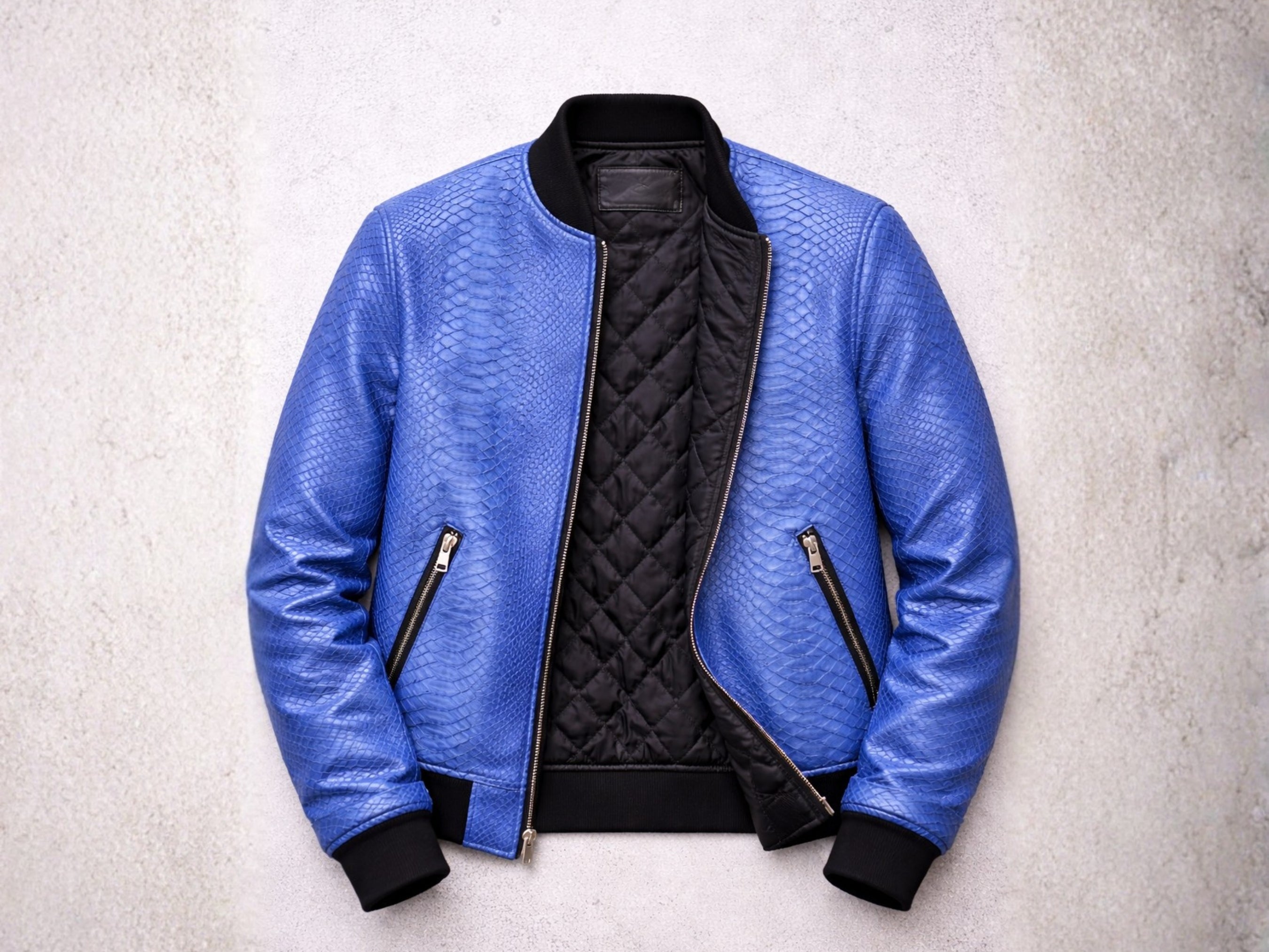 Blue snakeskin-textured bomber jacket with quilted inner lining, zip front, side zip pockets