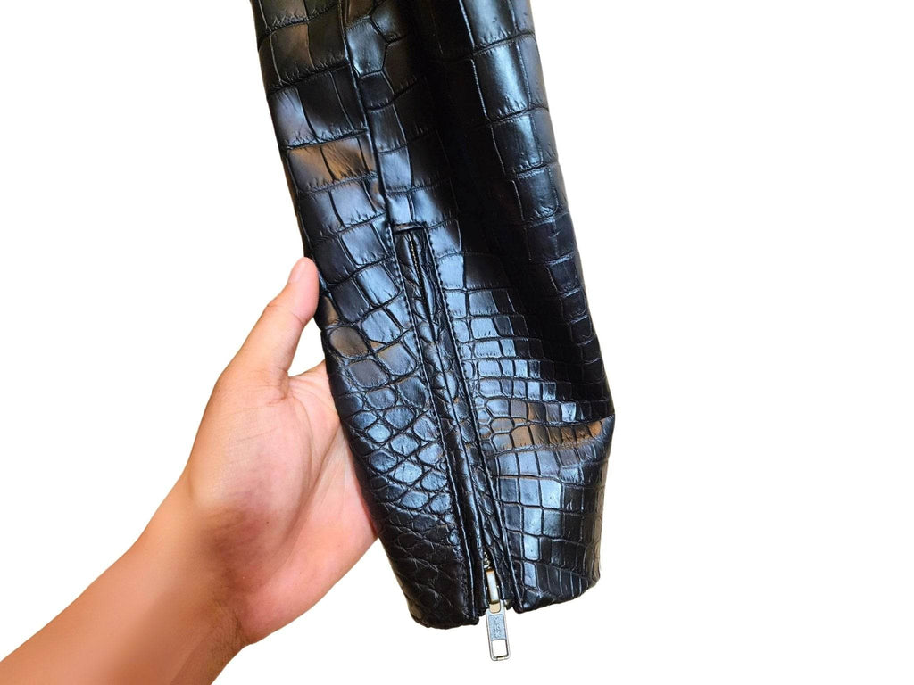 Alligator-skin jacket close-up with vertical zipper and glossy scale texture, dark blue.