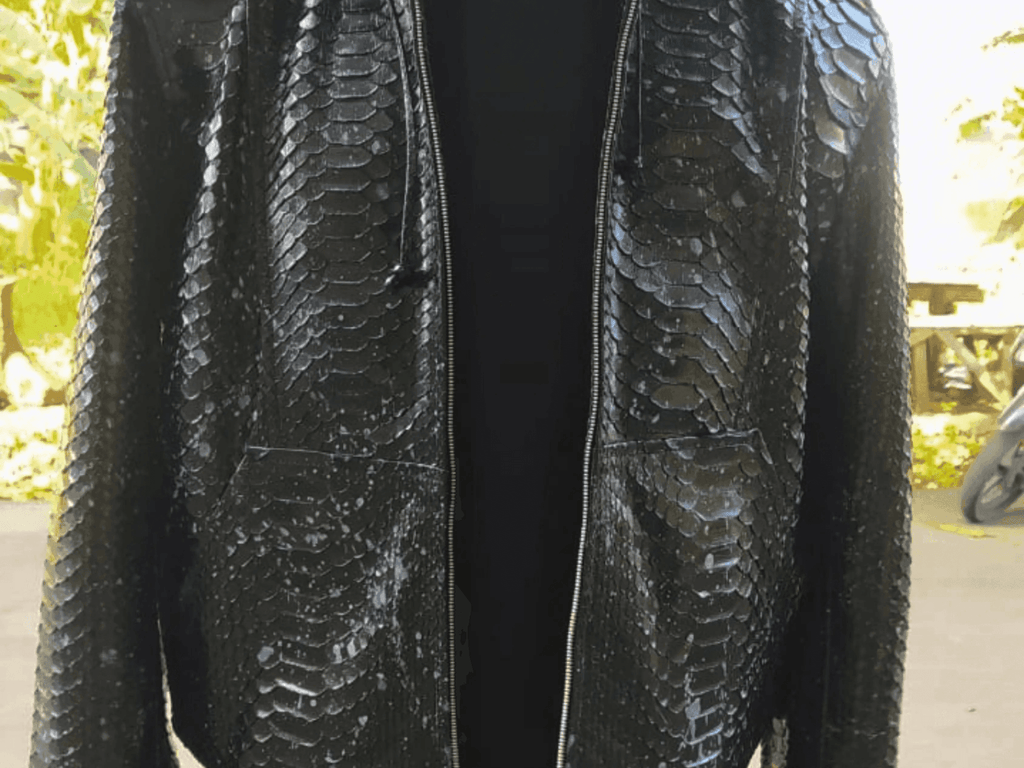 Black snakeskin-style zip hoodie jacket close-up, front panels and zipper