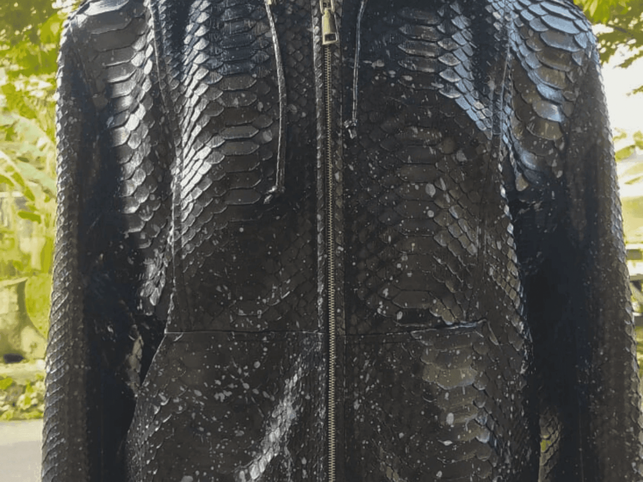 Black snakeskin-style zip hoodie jacket close-up, front center zipper detail