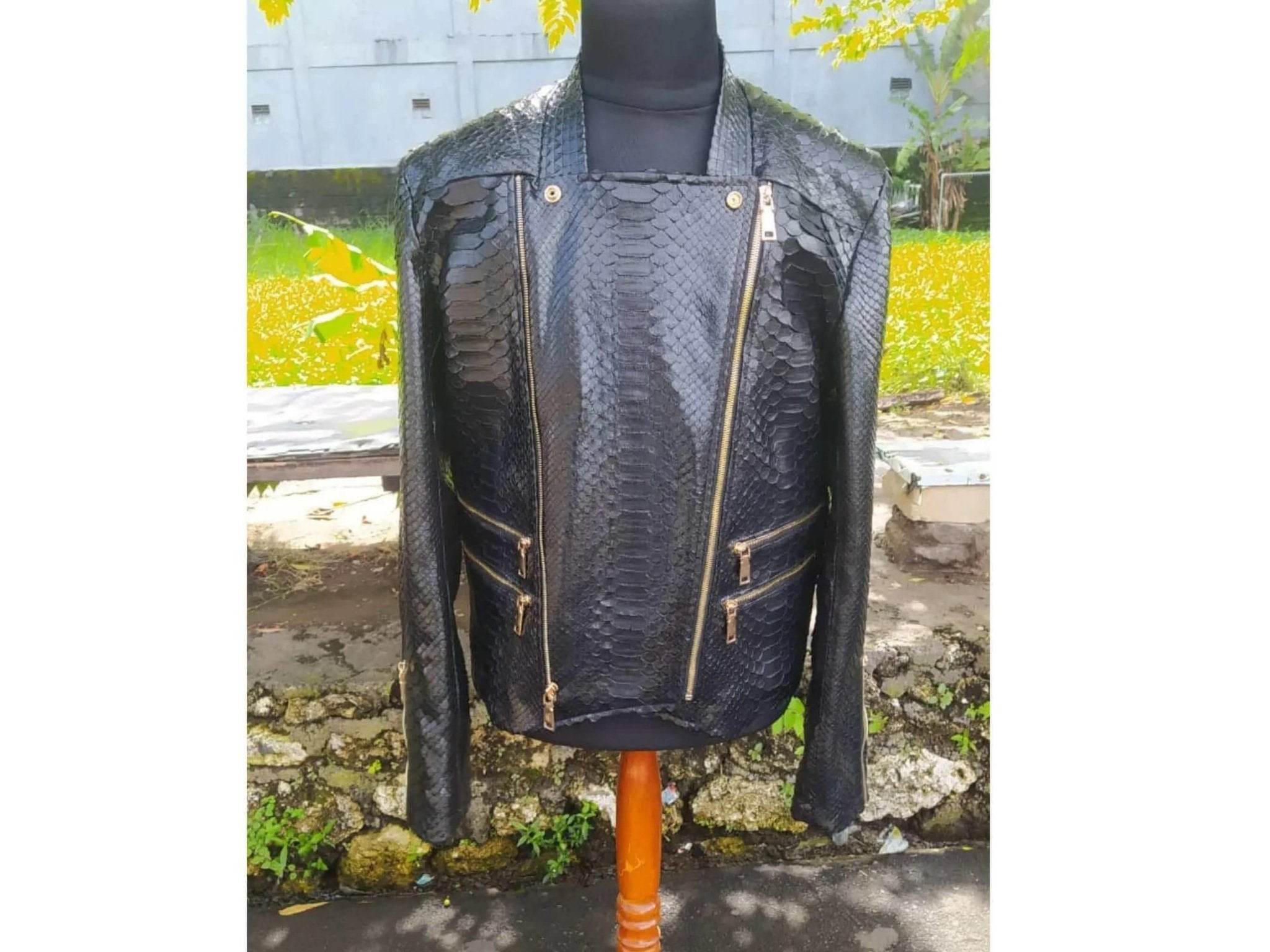 Black snakeskin leather jacket with gold-tone zippers and stand collar, front