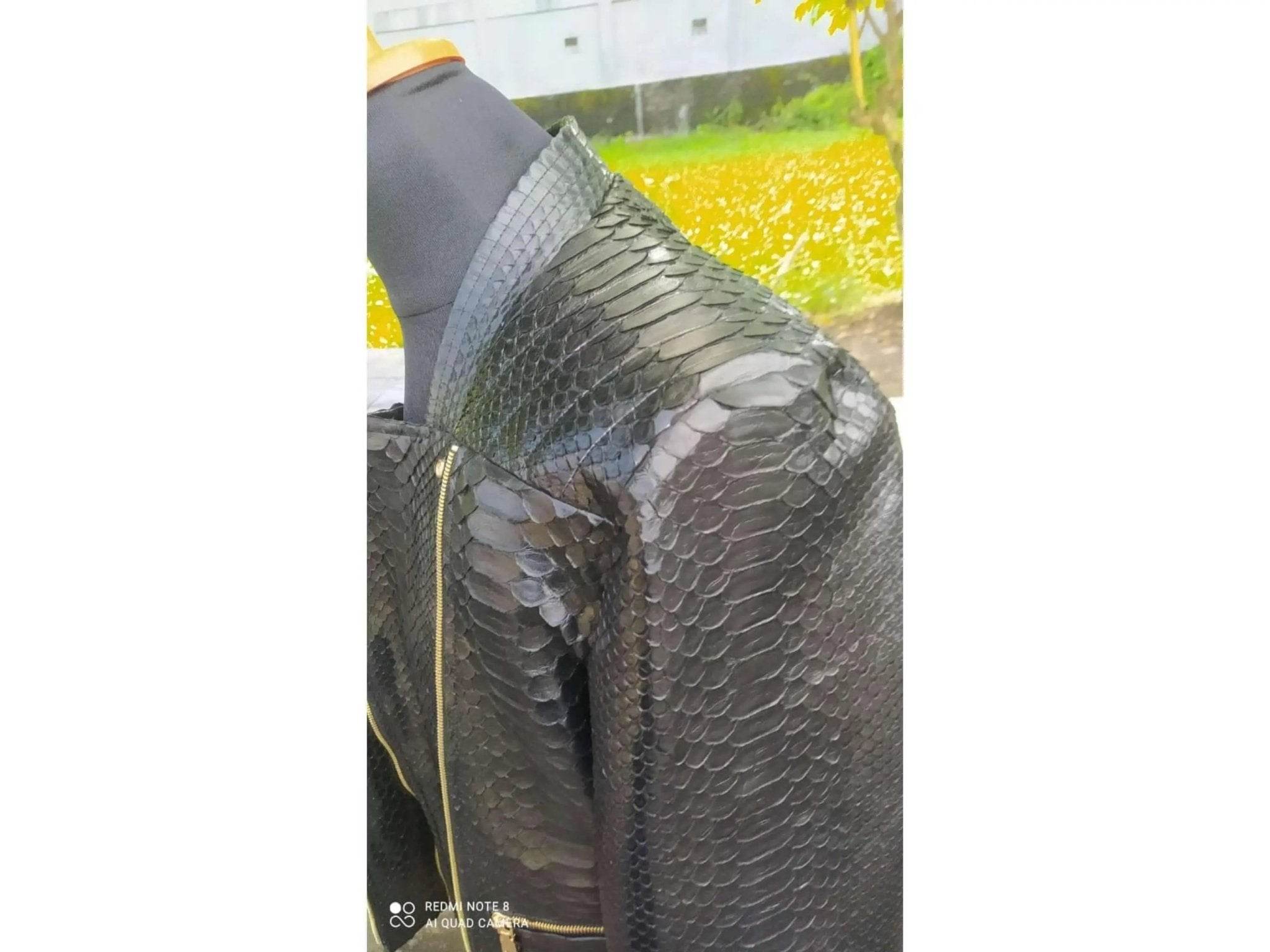 Black snakeskin leather jacket shoulder and sleeve detail, side angle