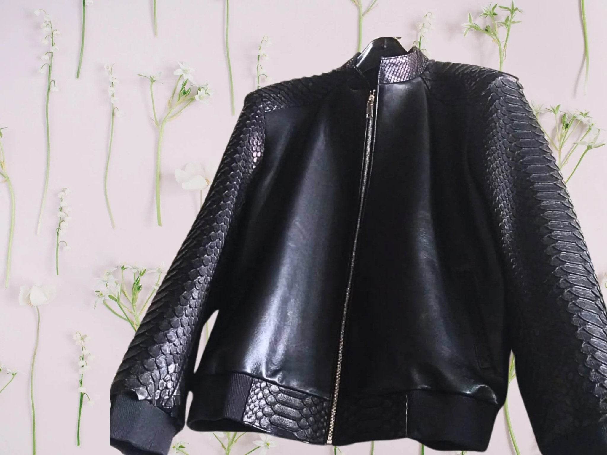 Black bomber leather jacket with stand collar, front zipper, and textured snakeskin-style sleeves