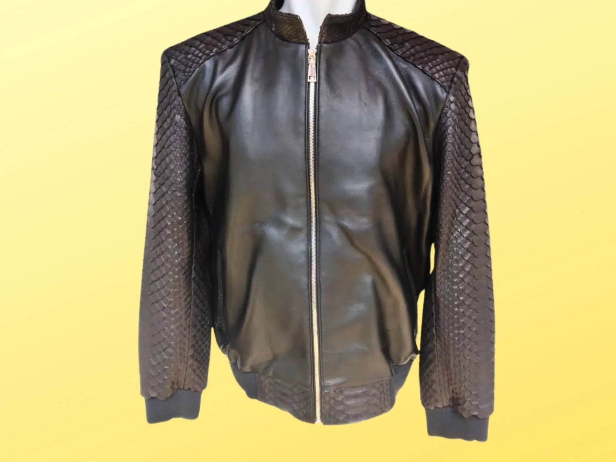 Black leather bomber jacket with front zipper, ribbed hem, and textured sleeve panels