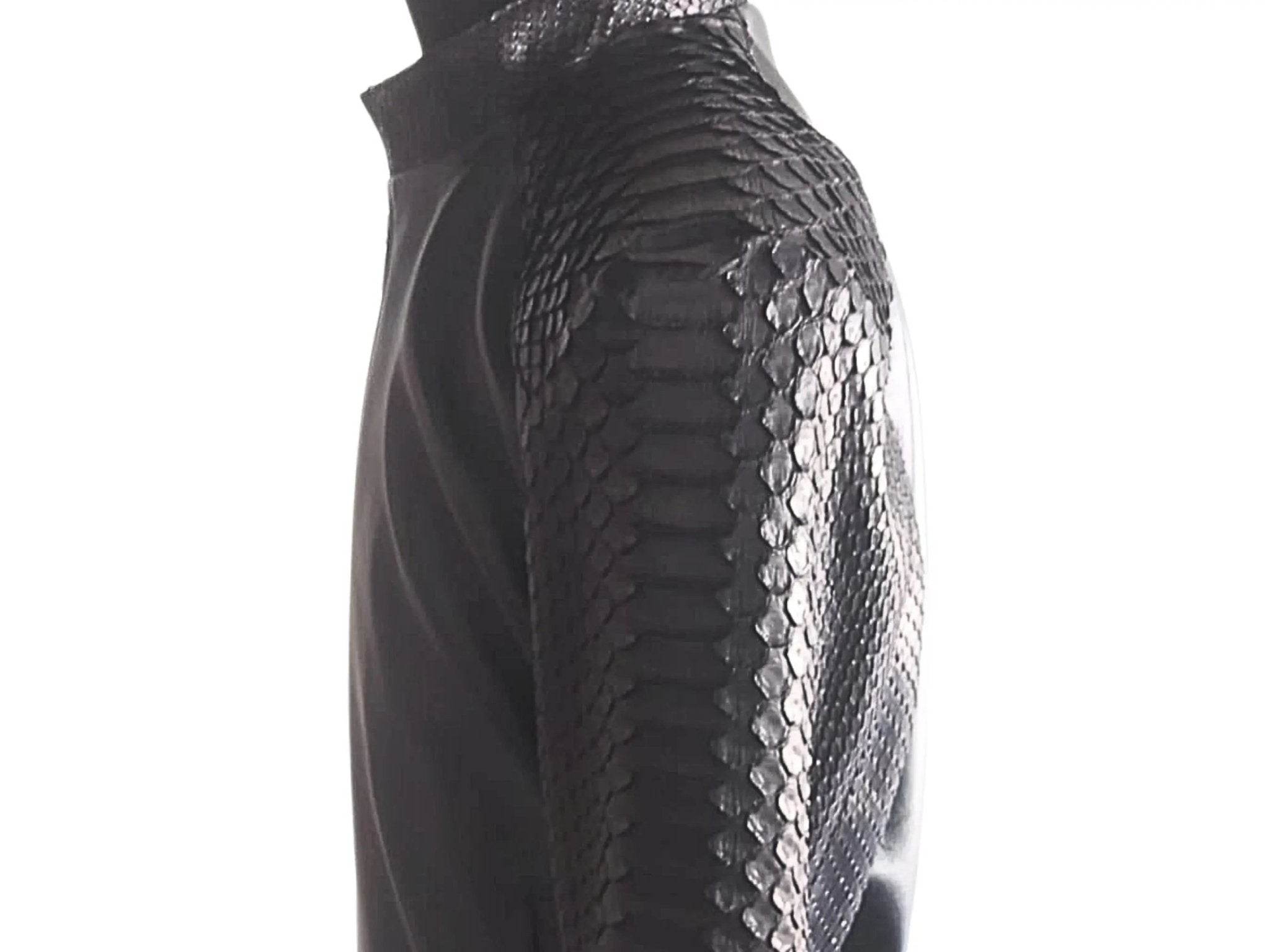 Black leather bomber jacket sleeve close-up with textured snakeskin-style pattern