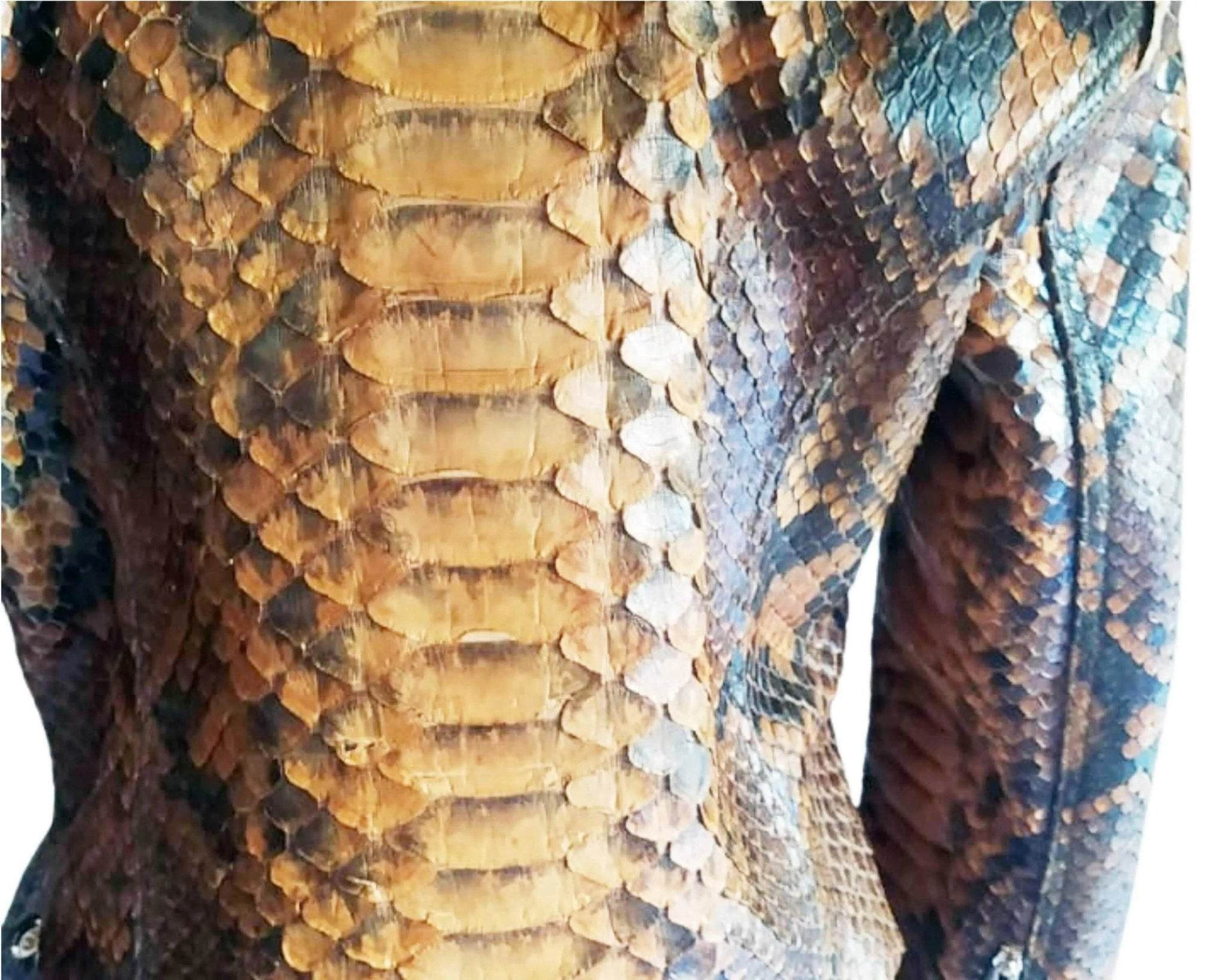 Close-up of snake-scale leather texture in gold, brown, and blue-gray tones
