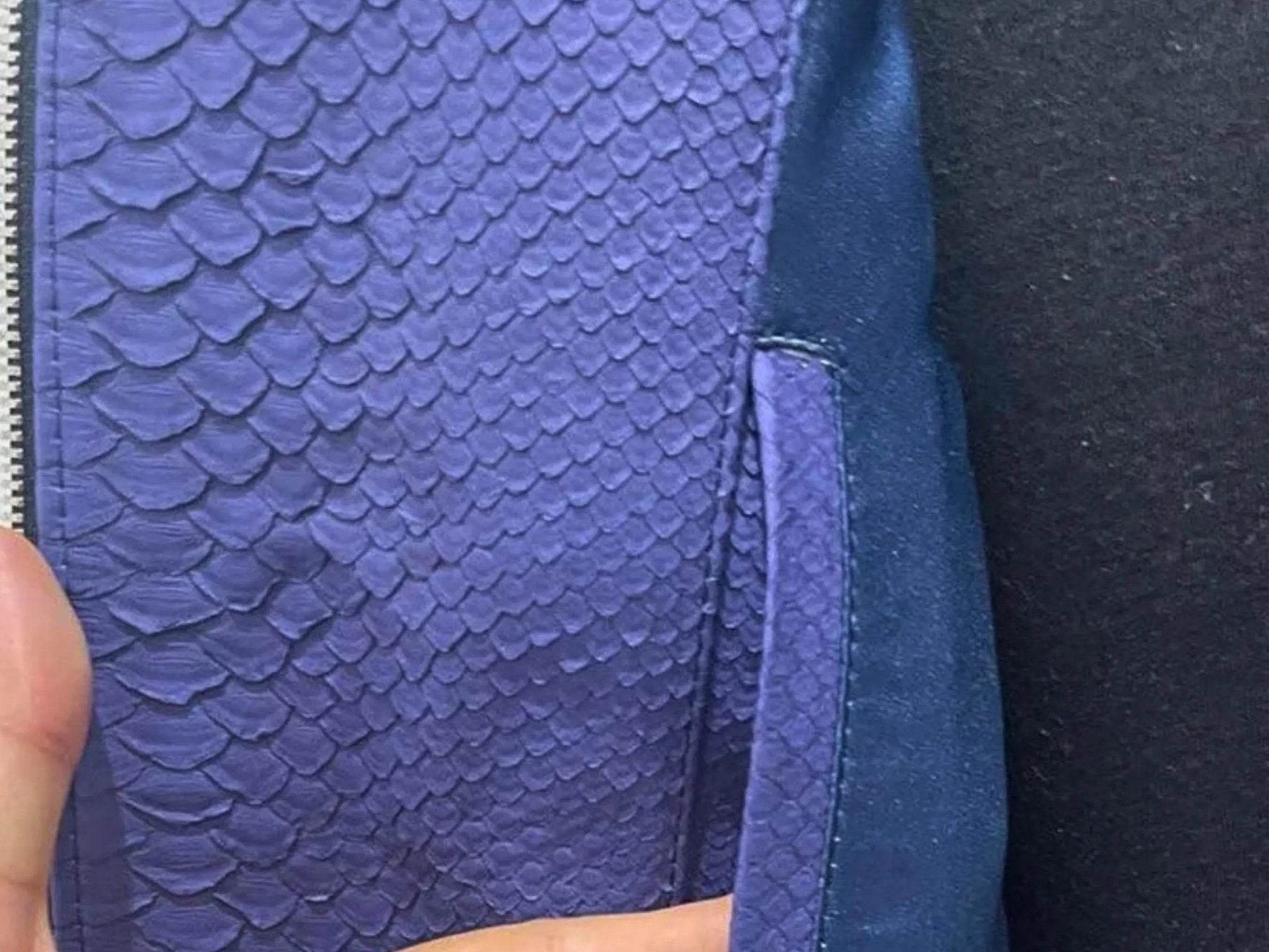 Blue snakeskin leather jacket sleeve panel with textured scales and stitched trim