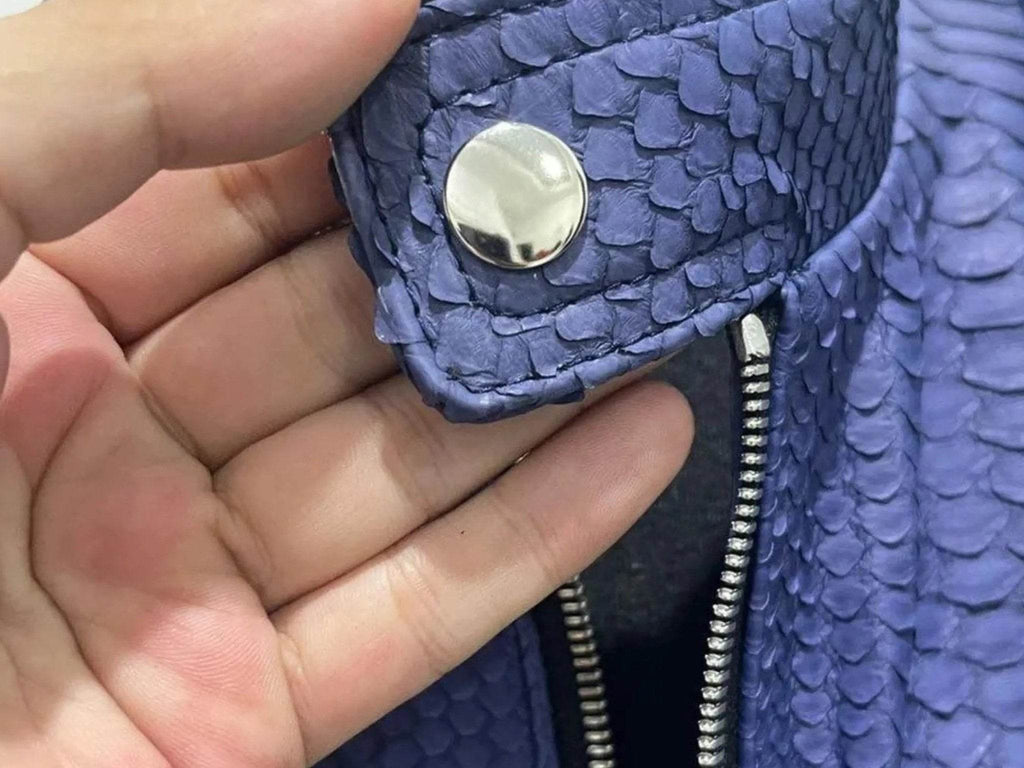 Blue snakeskin leather jacket detail with round snap stud and zipper
