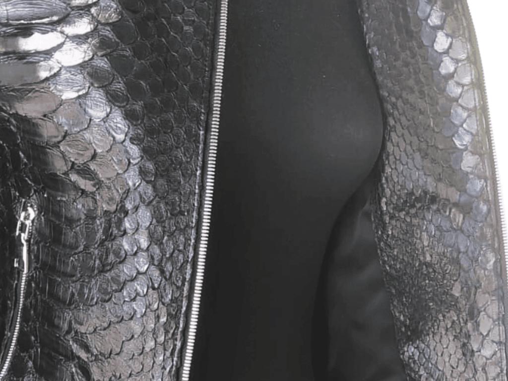 Close-up of genuine snakeskin motorcycle jacket: textured leather panel and zipper