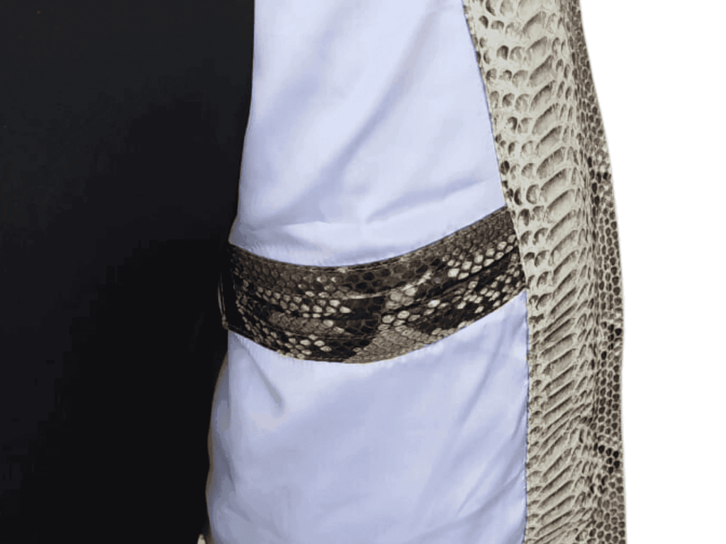 Snakeskin quilt jacket close-up at waist, black-and-tan scale pattern, curved hem