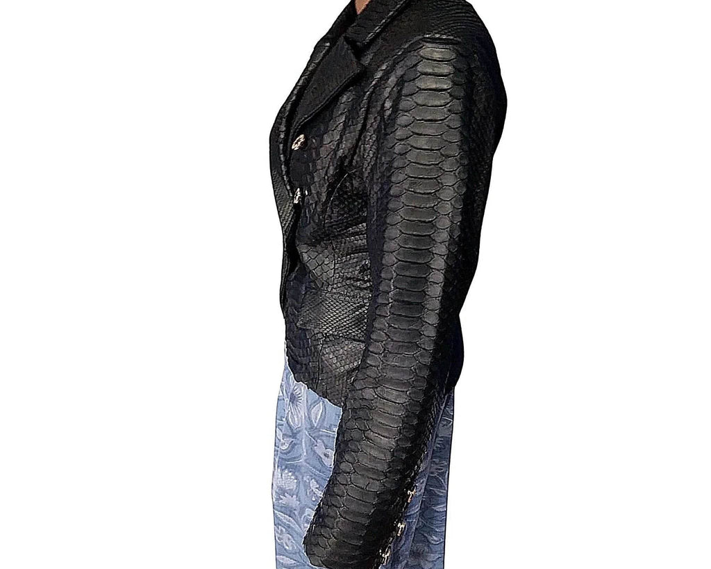 Snakeskin-look blazer sleeve with scale texture and dark underlayer.