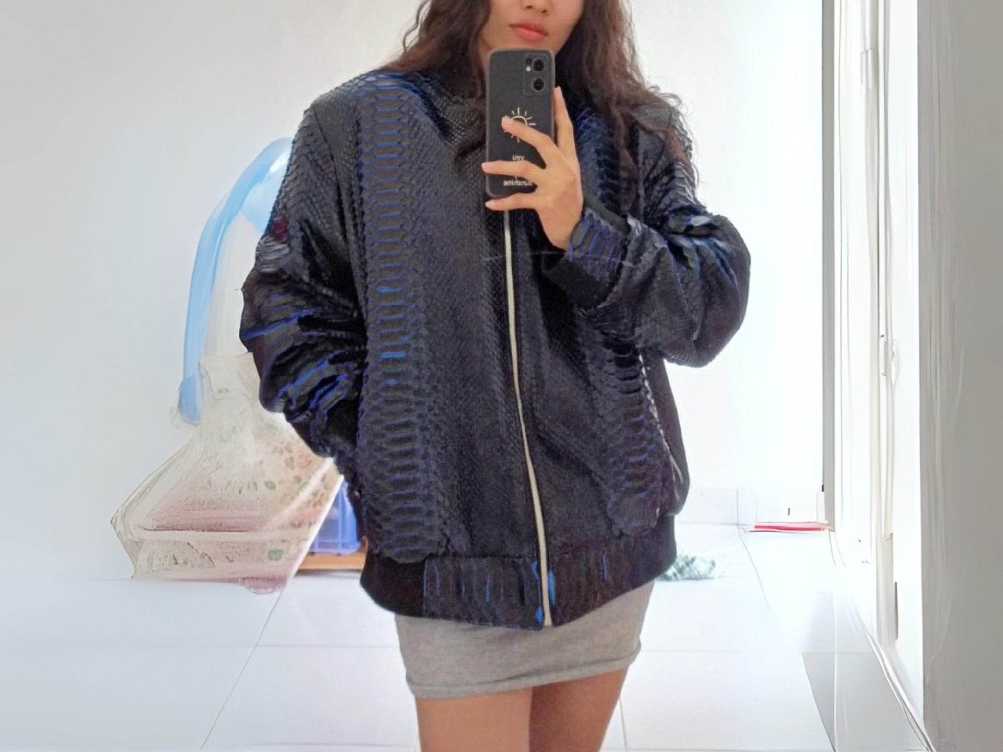 Snakeskin bomber jacket with dark blue scaly pattern, zip front, and ribbed hem