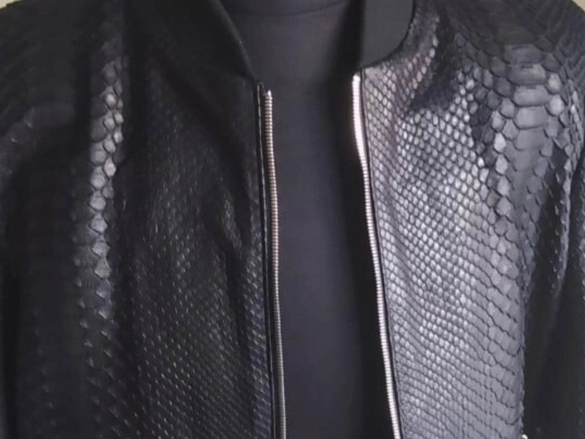 Snakeskin leather jacket front zipper and textured pattern close-up