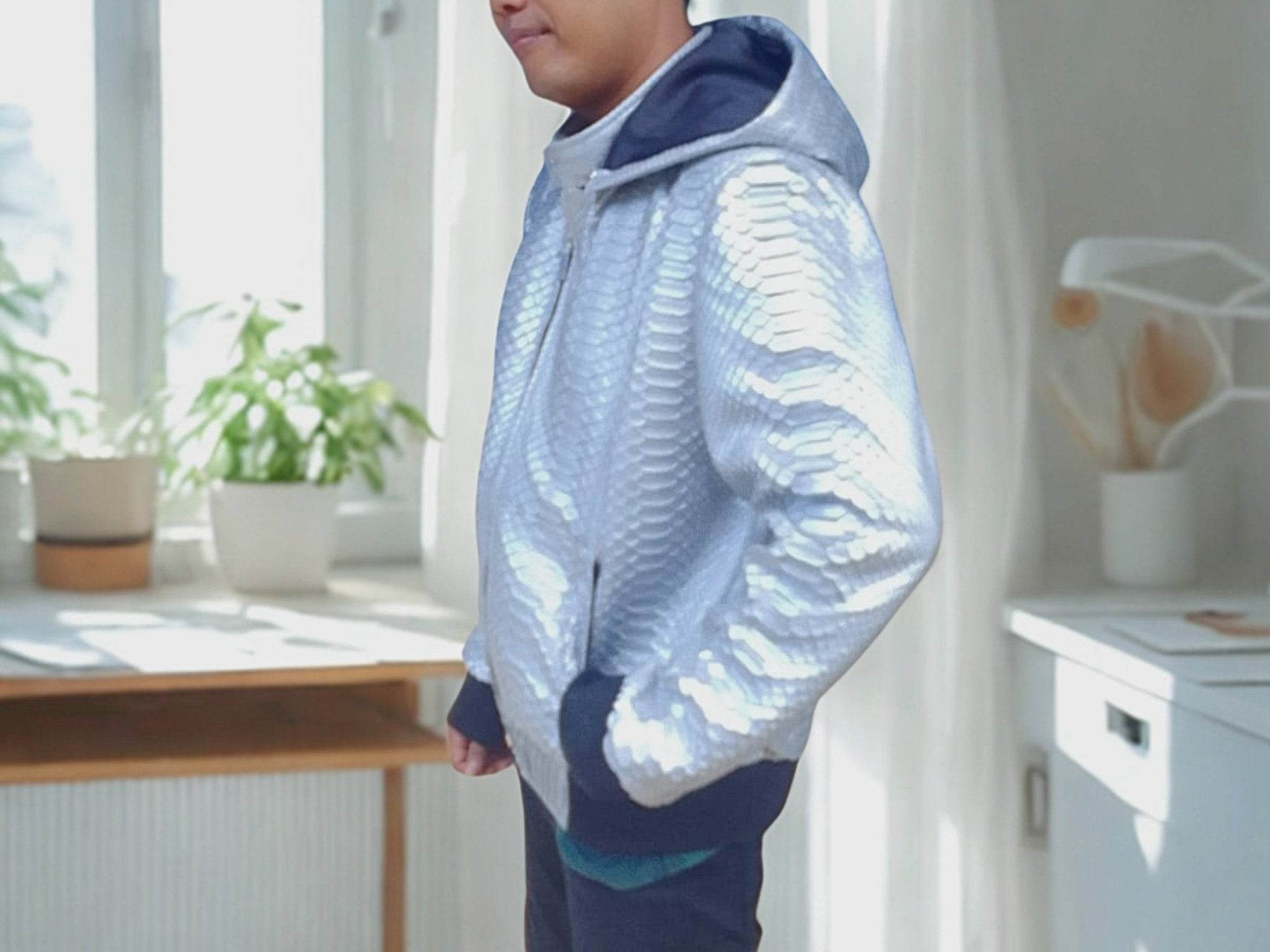 Light blue snakeskin-pattern hoodie jacket with hood and full front zipper.