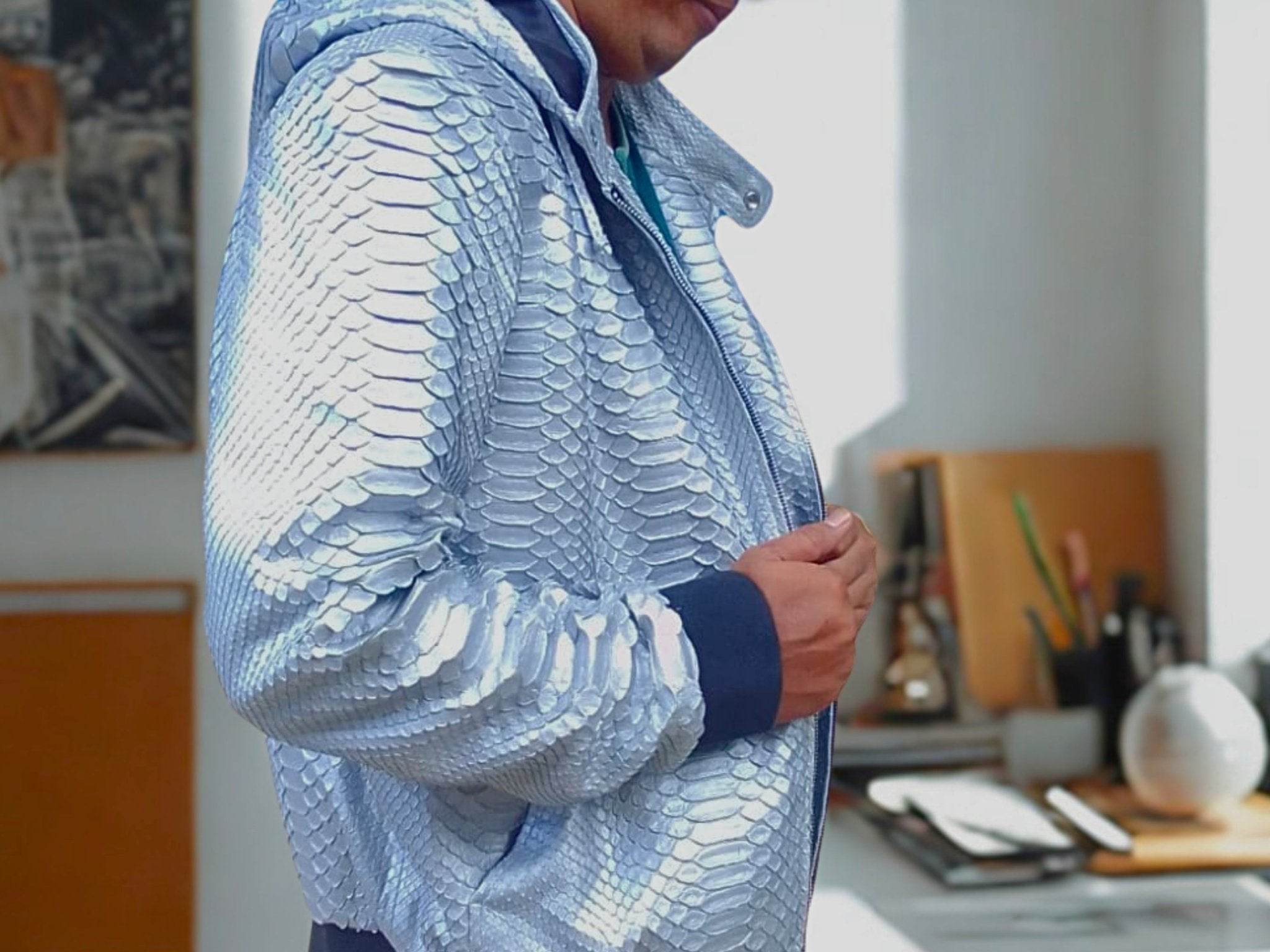 Light blue snakeskin-texture zip hoodie jacket with stand collar and full zipper.