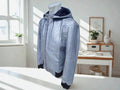 Light blue snakeskin-pattern zip hoodie jacket on a mannequin, hood and cuffs.