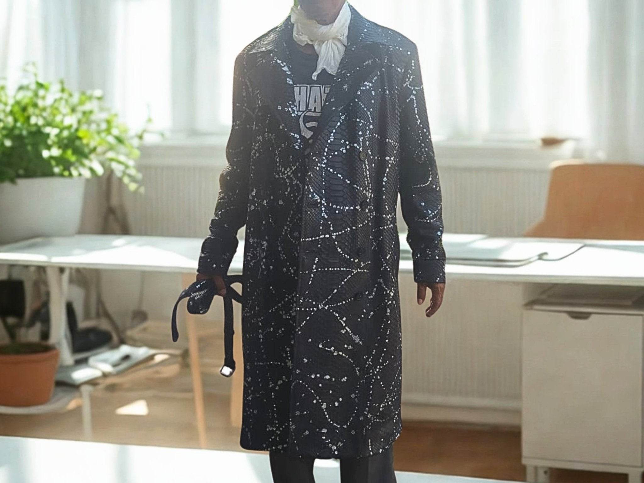 Dark long coat with snakeskin-like pattern and waist belt tie, front view